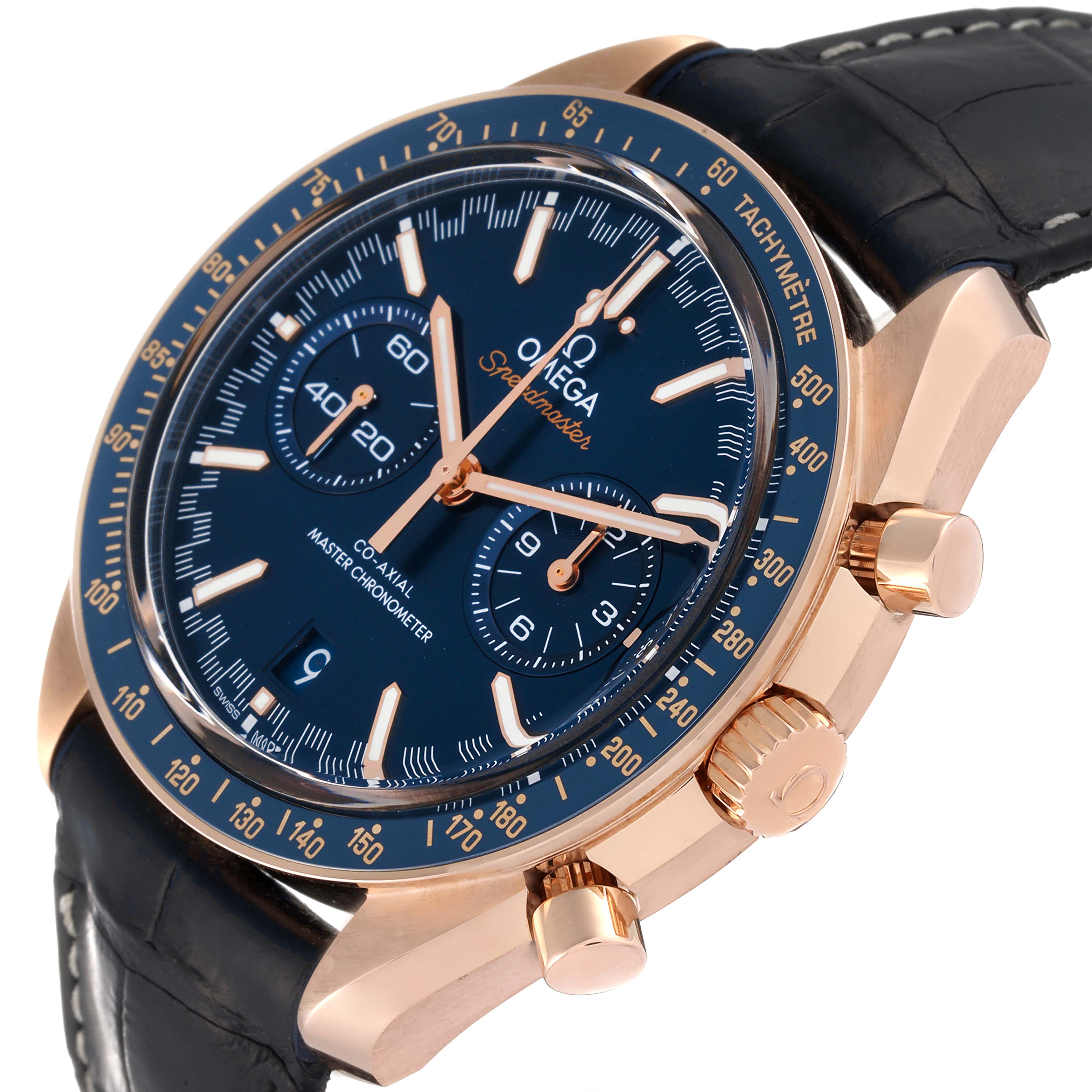 The image shows an Omega Speedmaster 329.53.44.51.03.001 Men's Rose Gold Blue Dial 329.53.44.51.03.001 Men's Rose Gold Blue Dial watch at an angle, displaying its face, crown, pushers, and part of its strap.