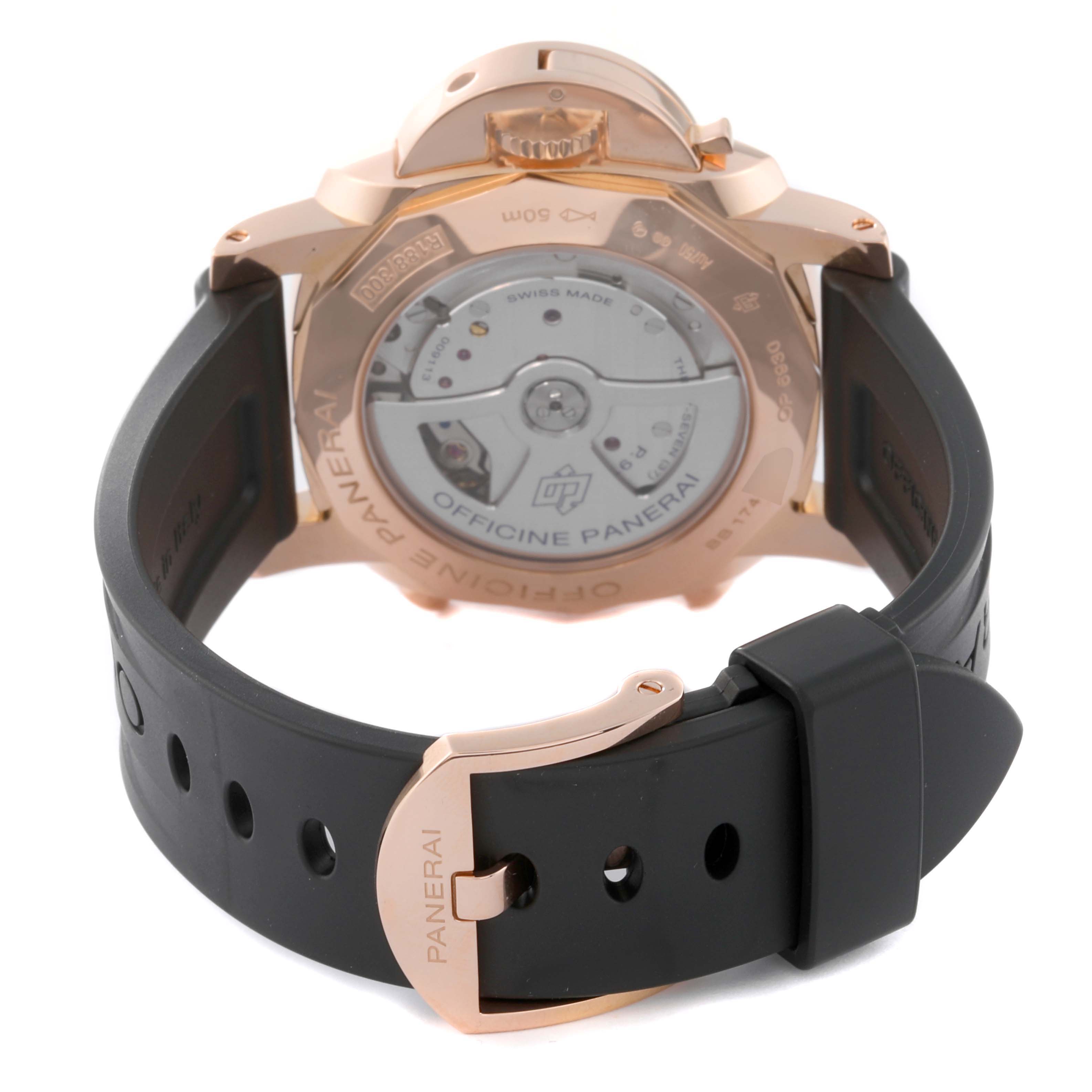 The image shows the back view of a Panerai Luminor PAM00525 Men's Rose Gold Black Dial PAM00525 Men's Rose Gold Black Dial watch, highlighting the case back, the movement, and the rubber strap with a Panerai buckle.