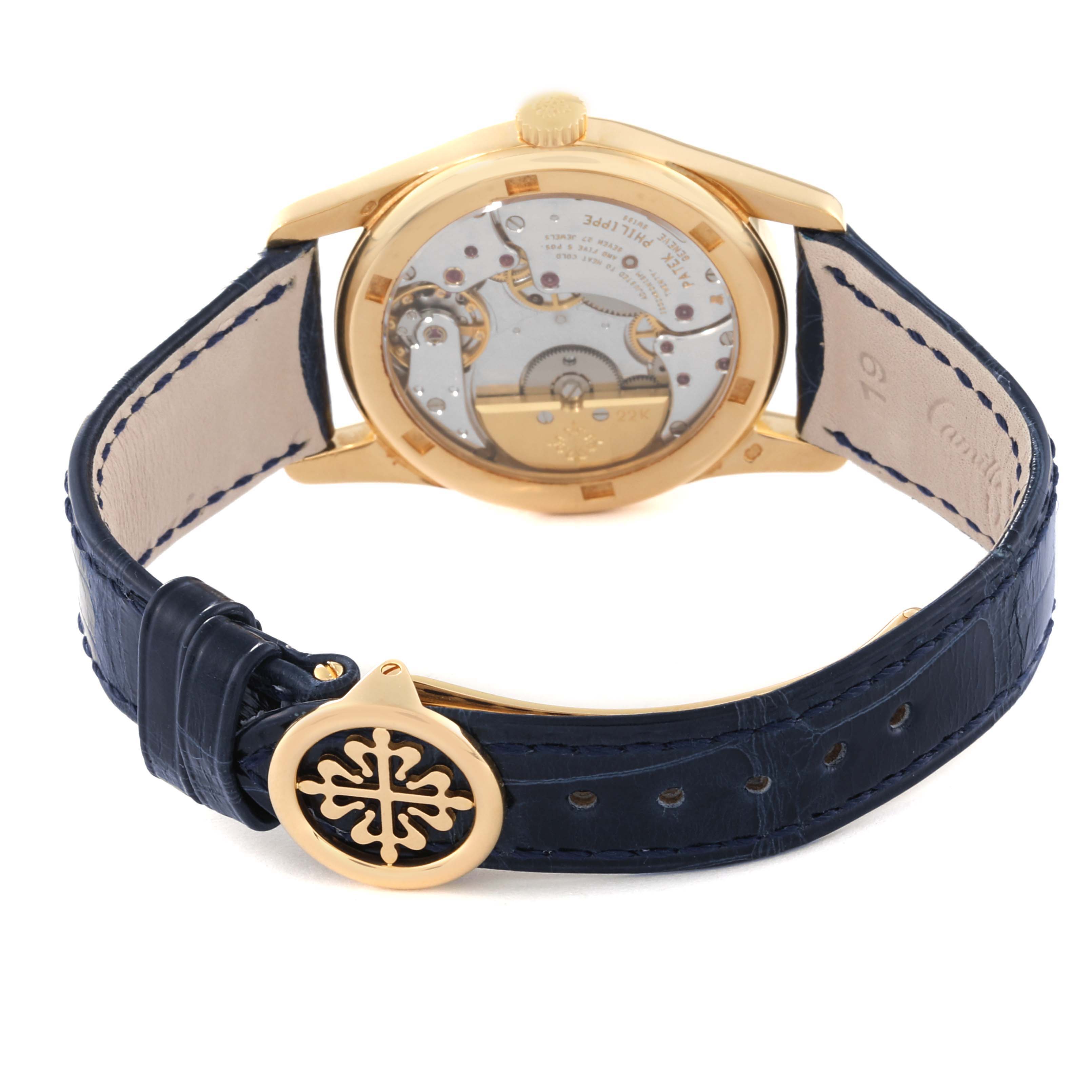The image shows the back of the Patek Philippe Calatrava 5000J Men's Yellow Gold Black Dial 5000J Men's Yellow Gold Black Dial watch, displaying the movement and blue leather strap with a branded buckle.