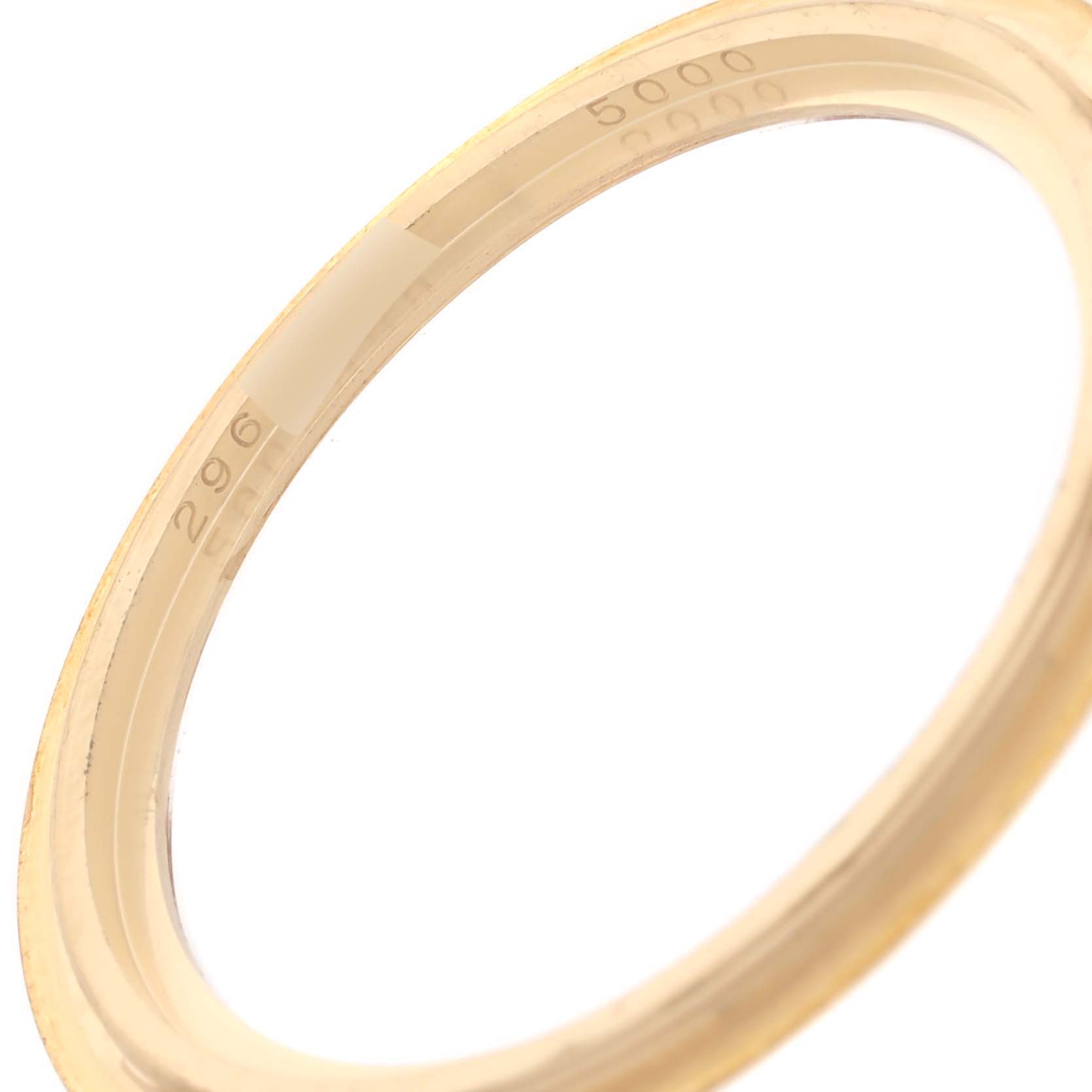 This image shows the gold bezel of a Calatrava model watch by Patek Philippe, viewed from an angled side perspective.