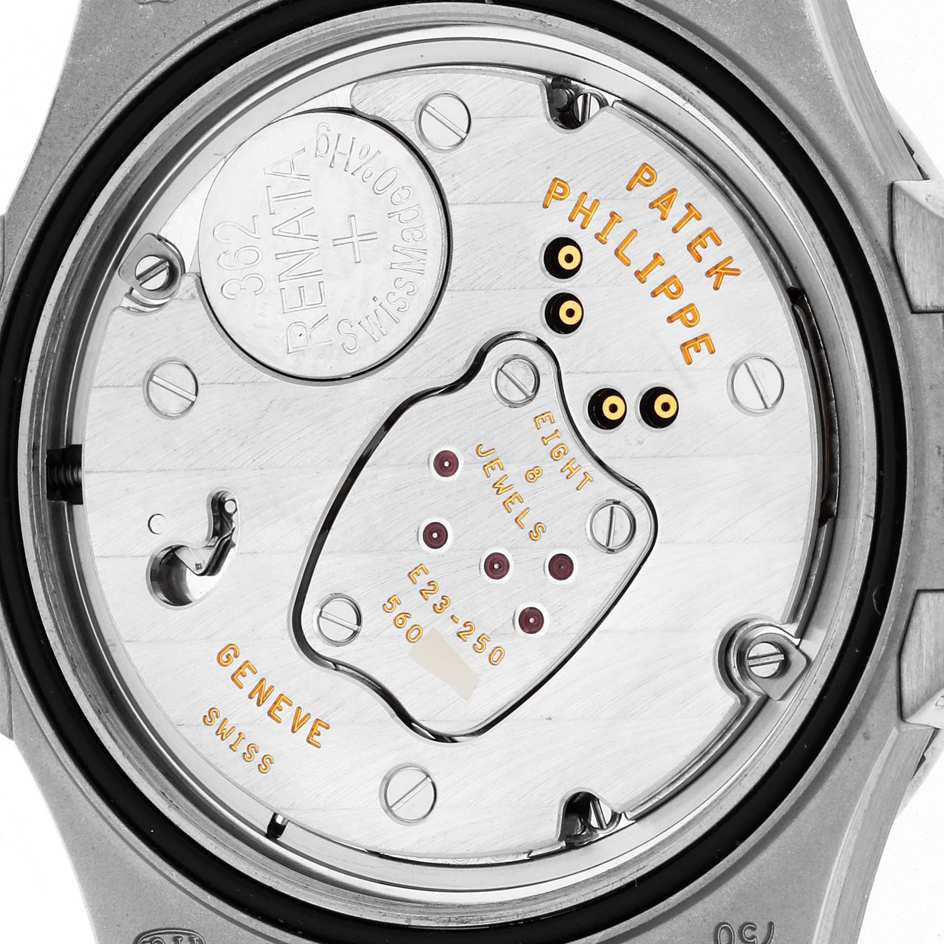 The image shows the back case and movement of a Patek Philippe Nautilus 7010 Women
s White Gold Silver Dial watch, highlighting its internal mechanics.