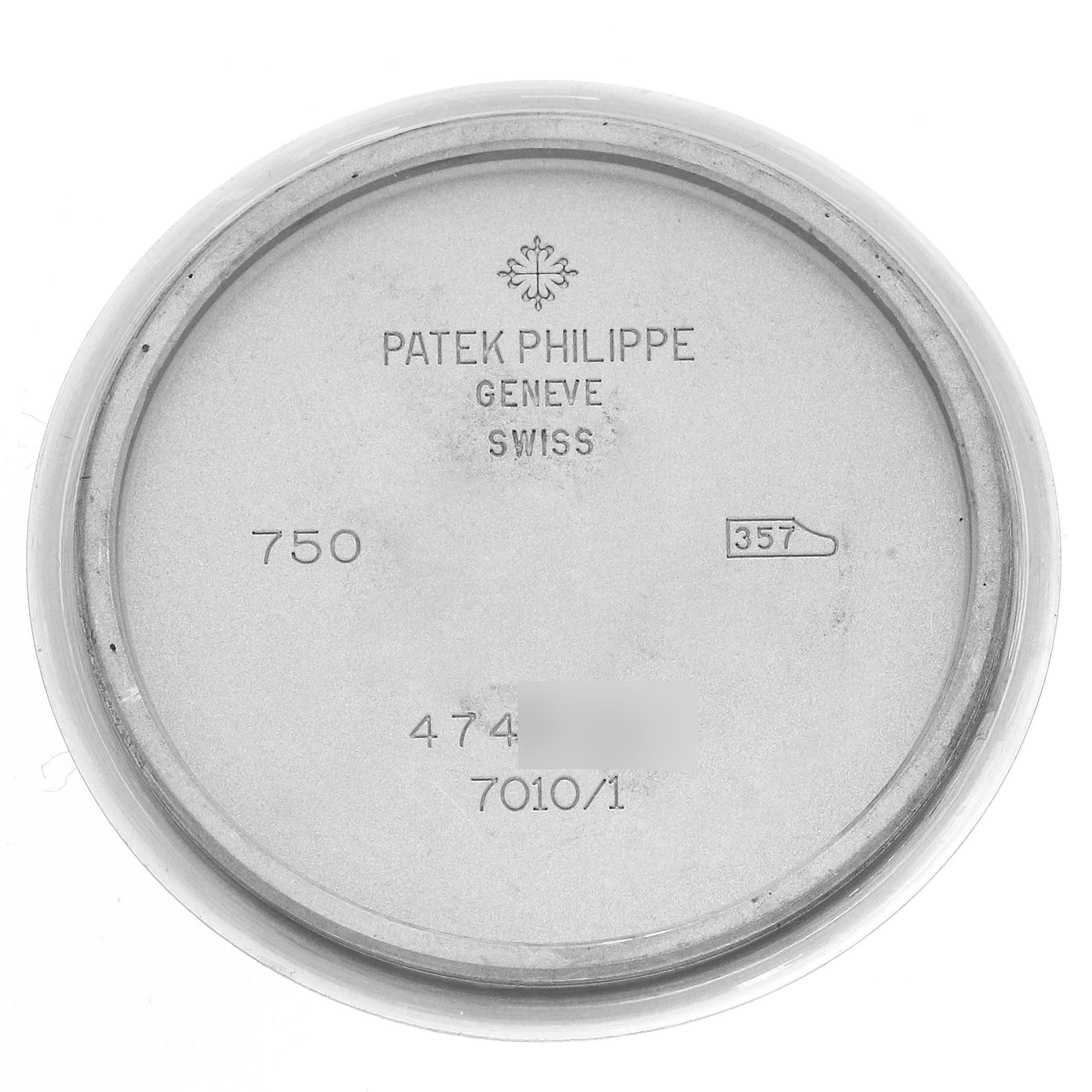 The image shows the inside case back of a Patek Philippe Nautilus 7010 Women
s White Gold Silver Dial watch, displaying engravings and model numbers.