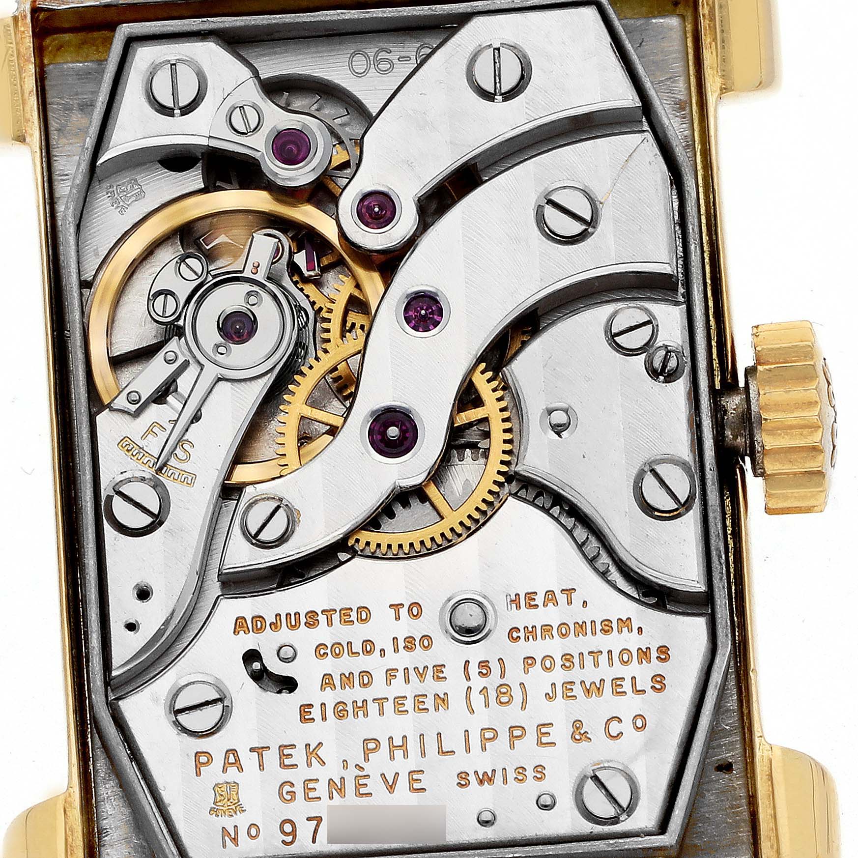 The image shows the movement of a Vintage Patek Philippe watch viewed from the back, highlighting gears and jewels.