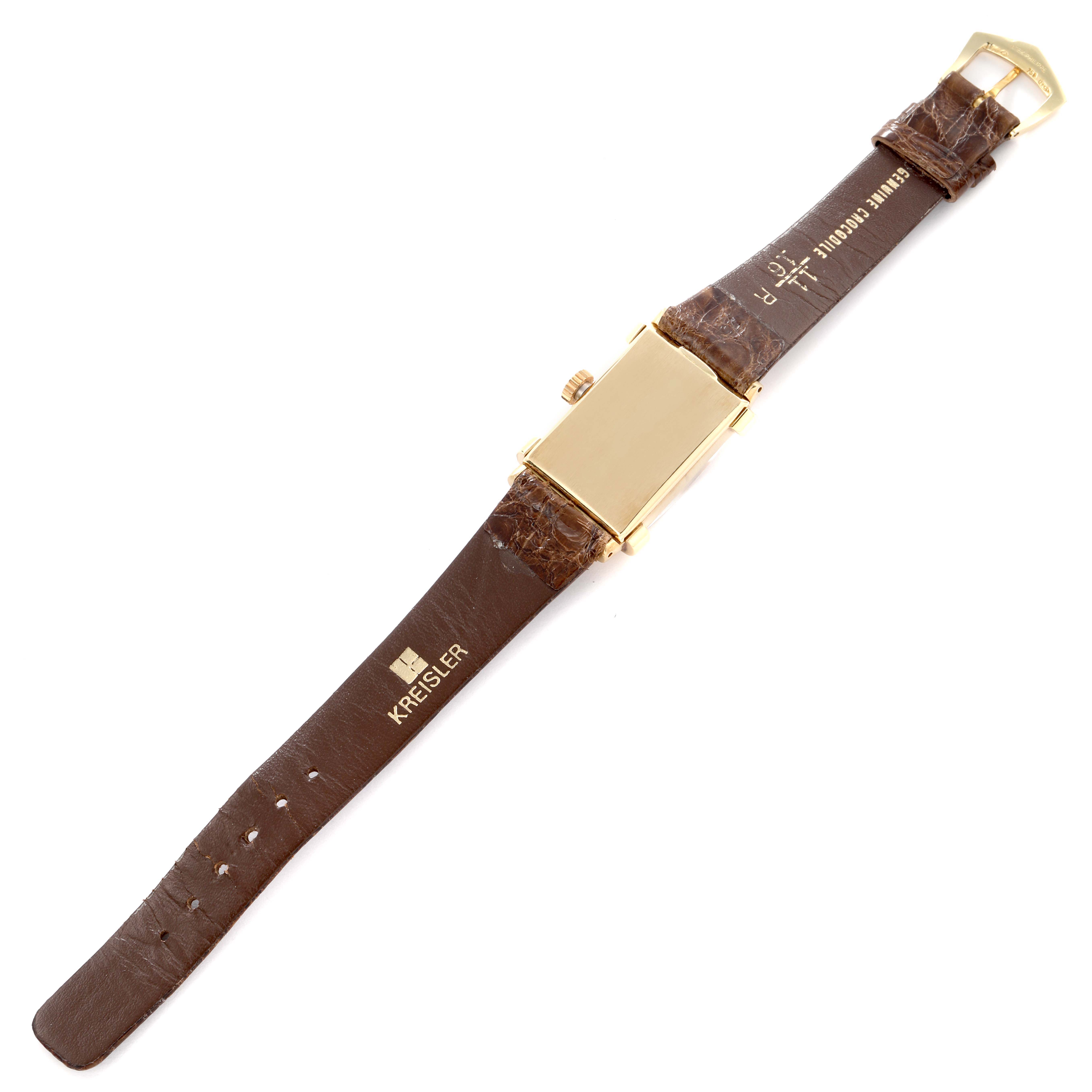 The image shows a Vintage Patek Philippe watch from the back, featuring a rectangular gold case and brown leather strap.