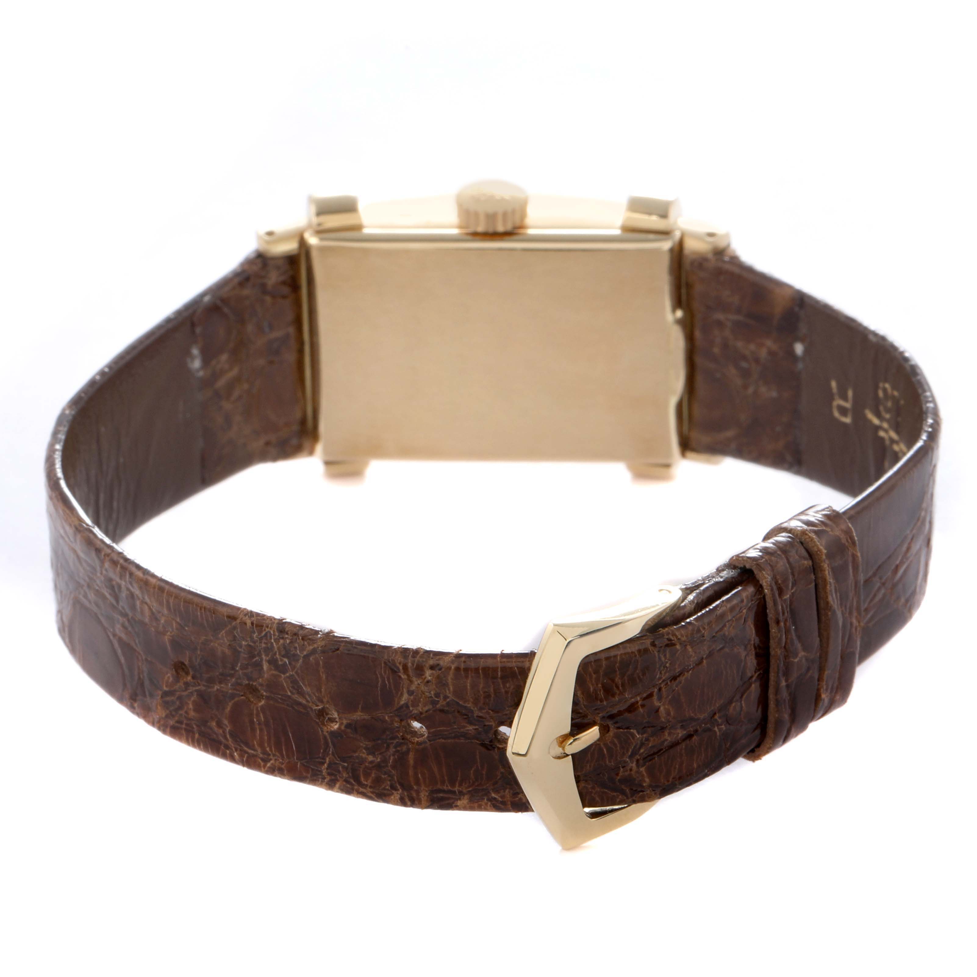 The Vintage model by Patek Philippe is shown from the rear, highlighting the case back, crown, and brown leather strap with buckle.