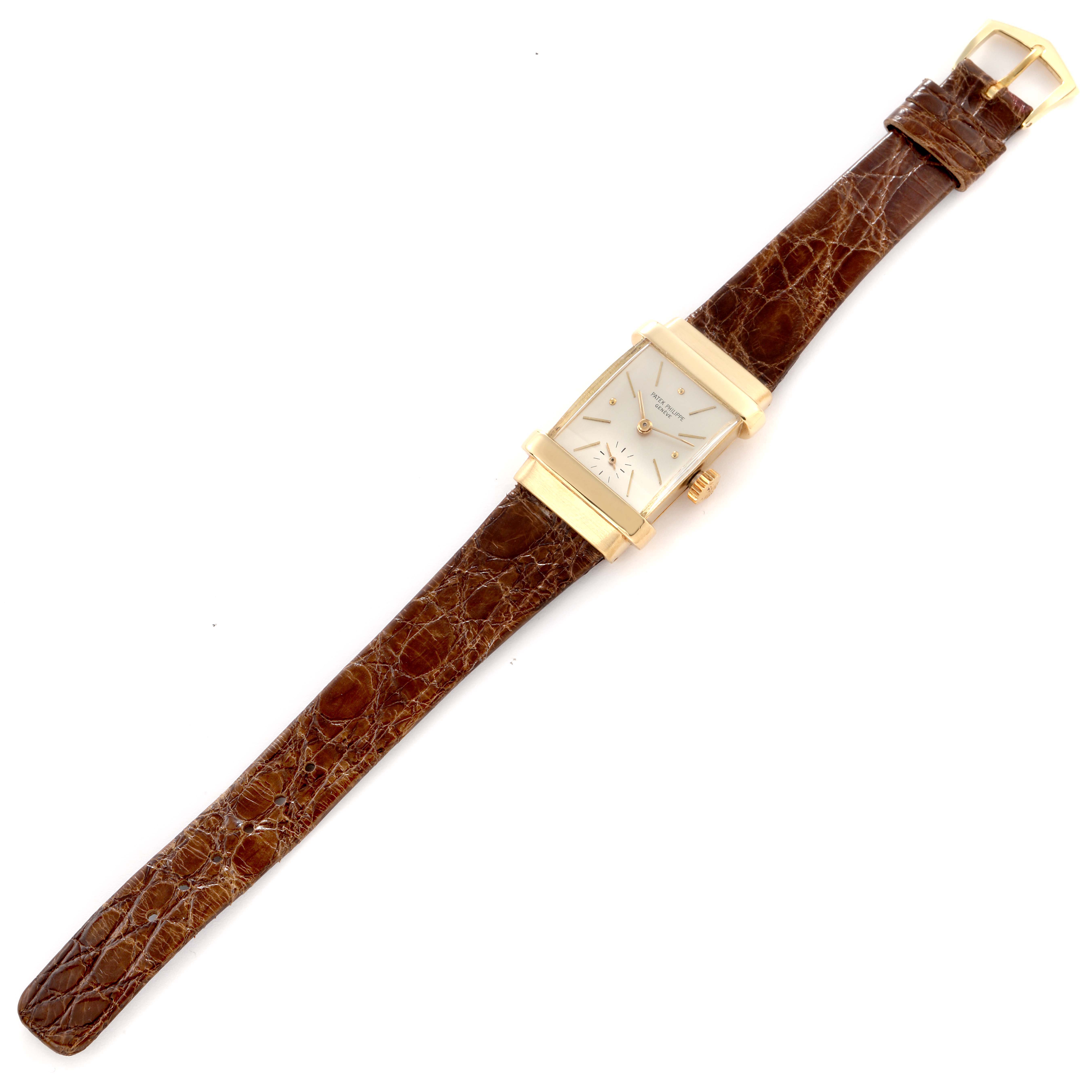 This Patek Philippe Vintage 1450 Men
s Yellow Gold Silver Dial model is shown from an overhead angle, displaying the full watch including the rectangular face and leather strap.