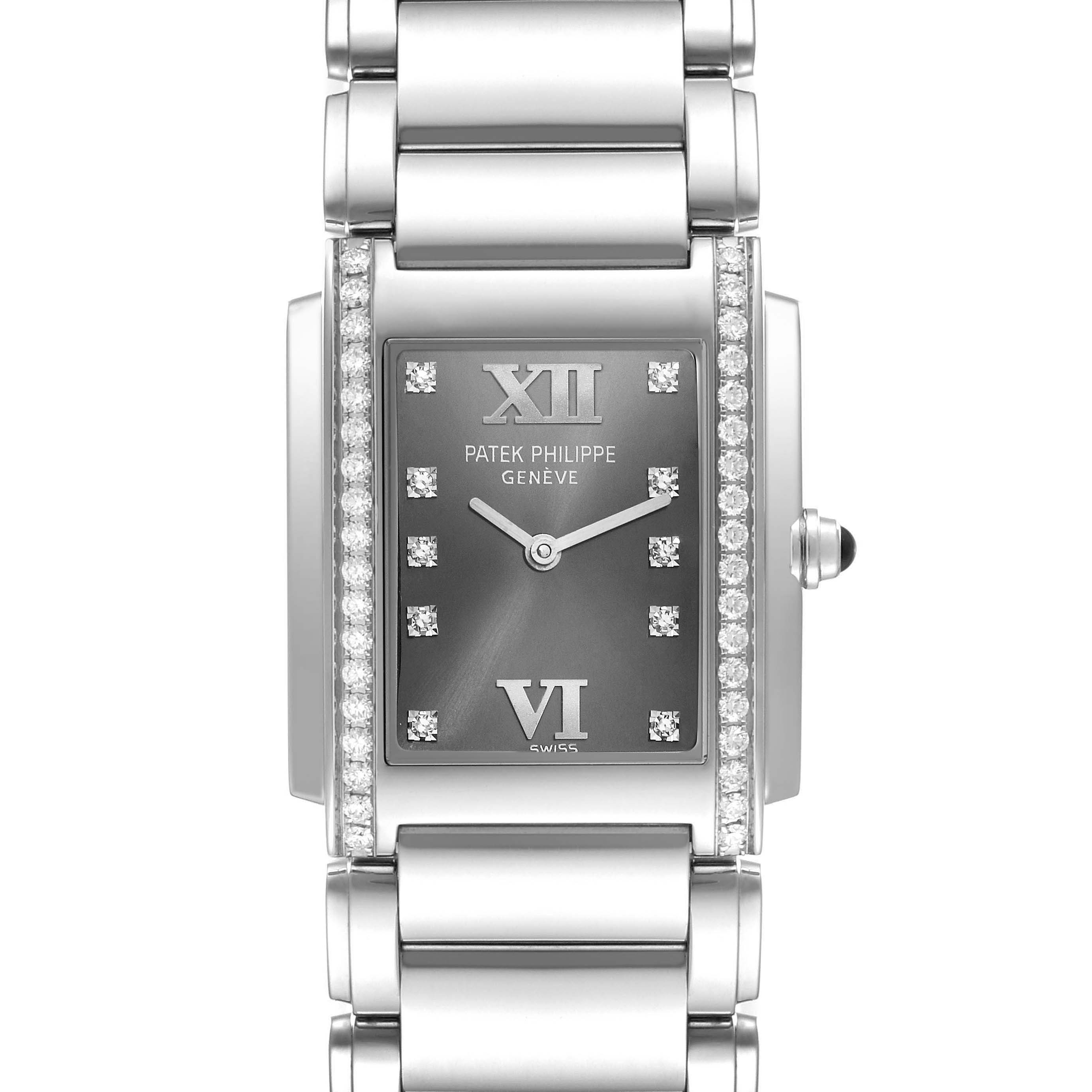 The image shows a frontal view of a Patek Philippe Twenty-4 4910 Women's Stainless Steel Grey Dial 4910 Women's Stainless Steel Grey Dial watch, highlighting its rectangular face, numerals, diamond accents, and metal bracelet.