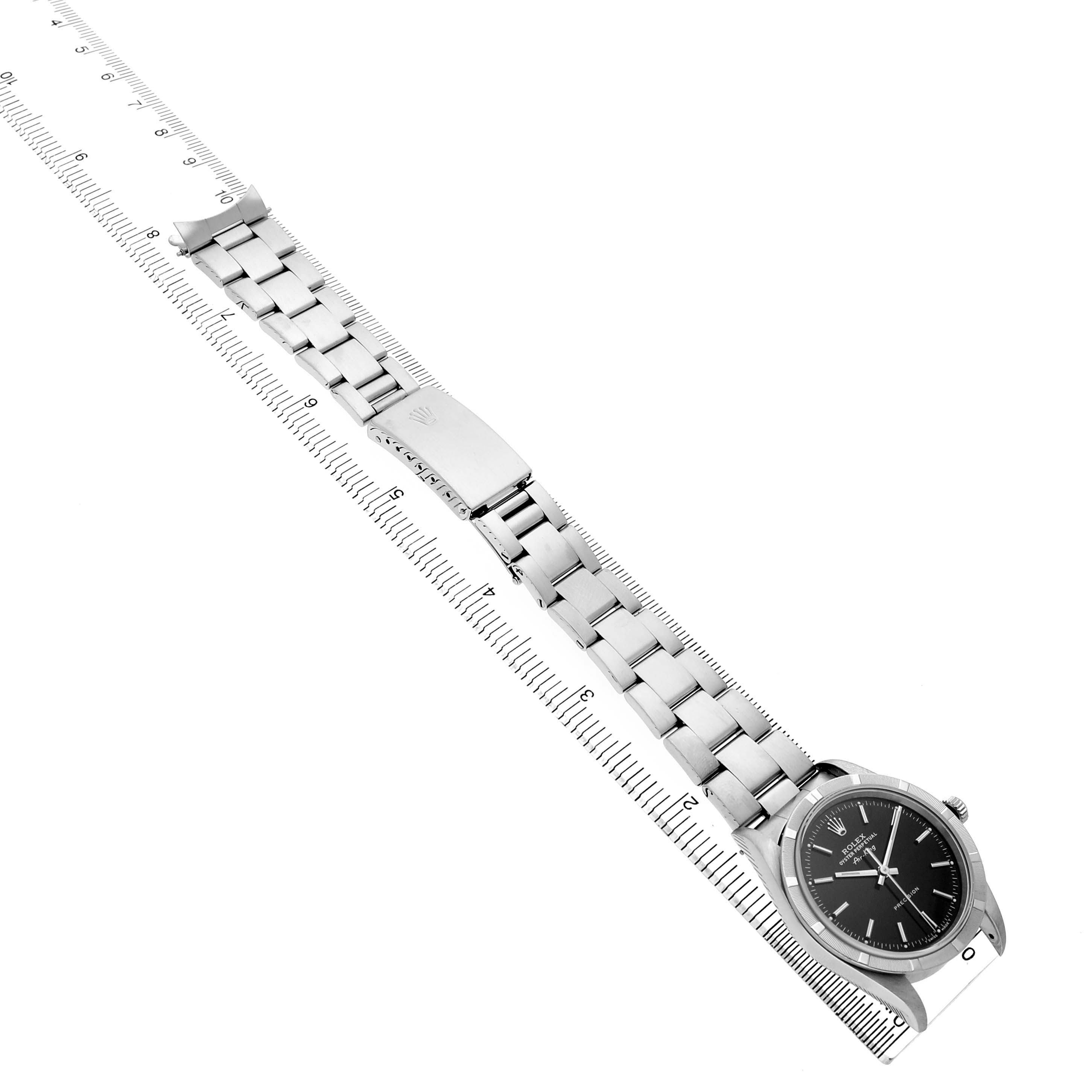 The image shows a side view of a Rolex Air-King 14010 Men's Stainless Steel Black Dial watch, displaying the bracelet, clasp, and watch face, alongside a ruler.