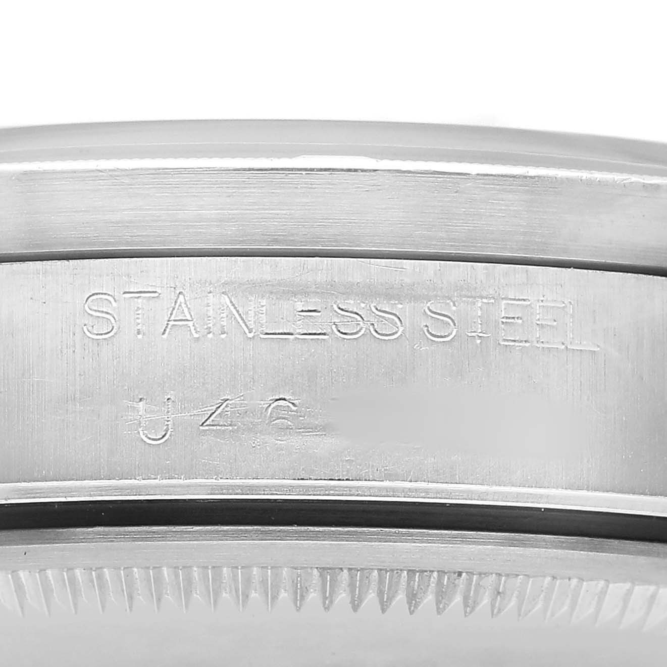 The image shows a close-up of the case back's side edge of a Rolex Air-King 14010 Men's Stainless Steel Black Dial, highlighting the engraving "STAINLESS STEEL."