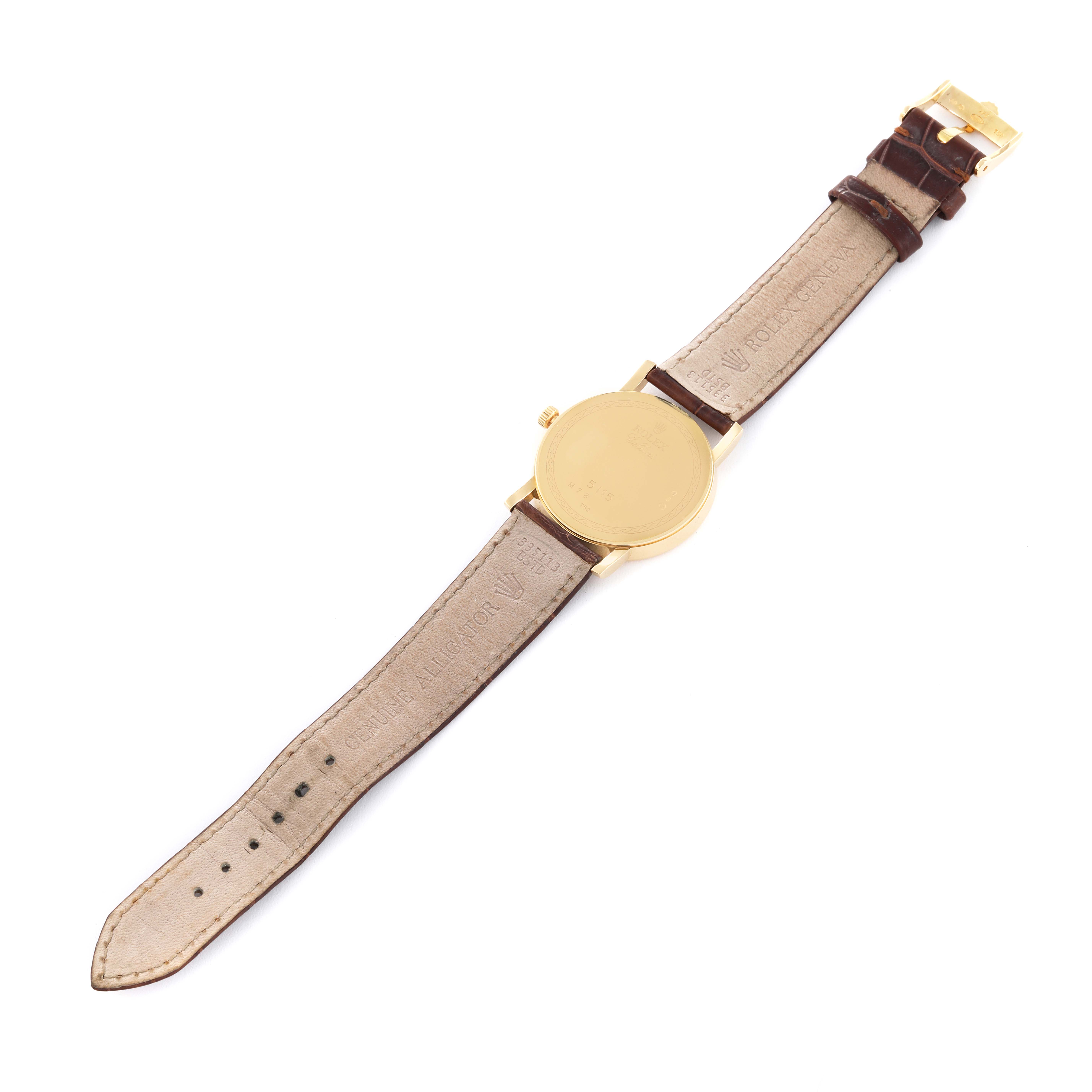 This image shows the back view of a Rolex Cellini 5115 Men's Yellow Gold Silver Dial 5115 Men's Yellow Gold Silver Dial model watch, displaying its leather strap and gold case back.