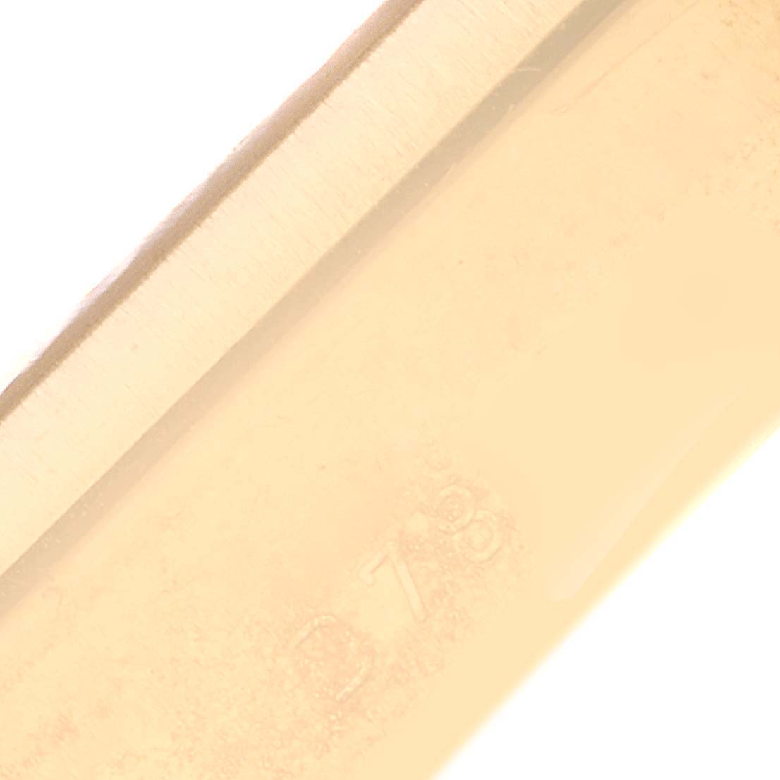 This image shows a close-up of a part of the Rolex Cellini 5440/8 Men's Yellow Gold Champagne Dial 5440/8 Men's Yellow Gold Champagne Dial watch, likely focusing on the watch's gold case or bracelet.