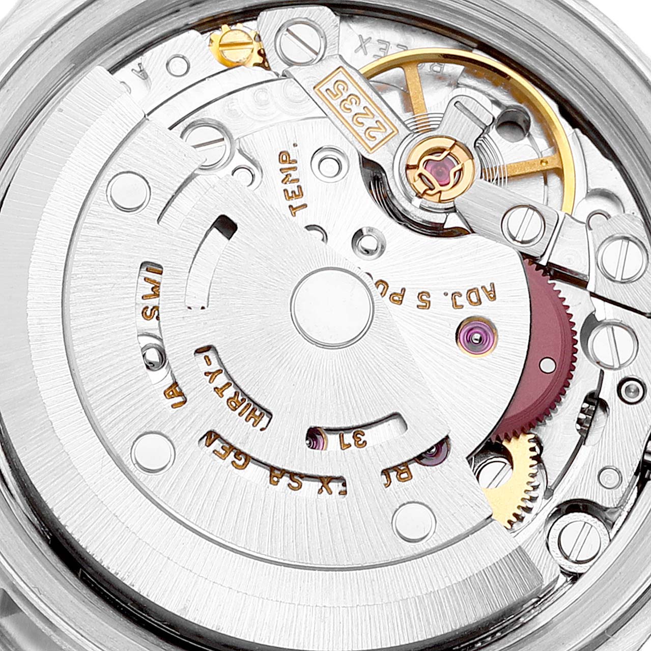 The image shows an internal view of the movement mechanism of a Rolex Datejust 79174 Women's Stainless Steel Silver Dial 79174 Women's Stainless Steel Silver Dial watch, highlighting gears, screws, and engravings.