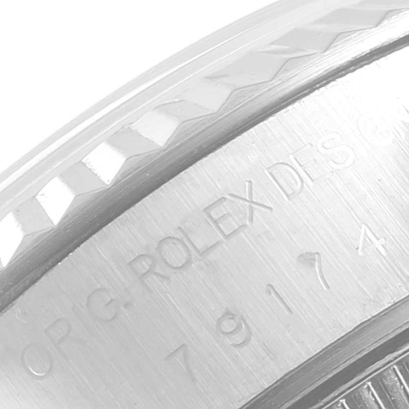This close-up image shows a partial view of the bezel and engraved side of a Rolex Datejust 79174 Women's Stainless Steel Silver Dial 79174 Women's Stainless Steel Silver Dial watch.
