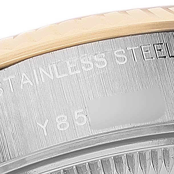 The image shows a close-up of the side of a Rolex Datejust 79173 Women
s Steel and Gold (two tone) Grey Dial 79173 Women
s Steel and Gold (two tone) Grey Dial watch with part of the serial number engraved on the stainless steel case.