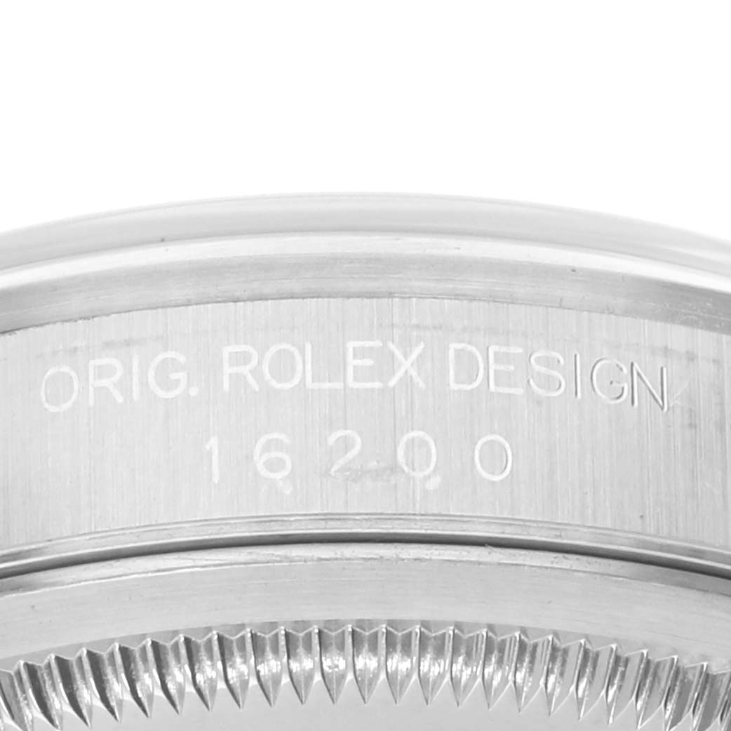 This image shows a close-up of the side view of a Rolex Datejust 16200 Men's Stainless Steel Silver Dial 16200 Men's Stainless Steel Silver Dial model 16200 bezel and casing with the engraving "ORIG. ROLEX DESIGN."