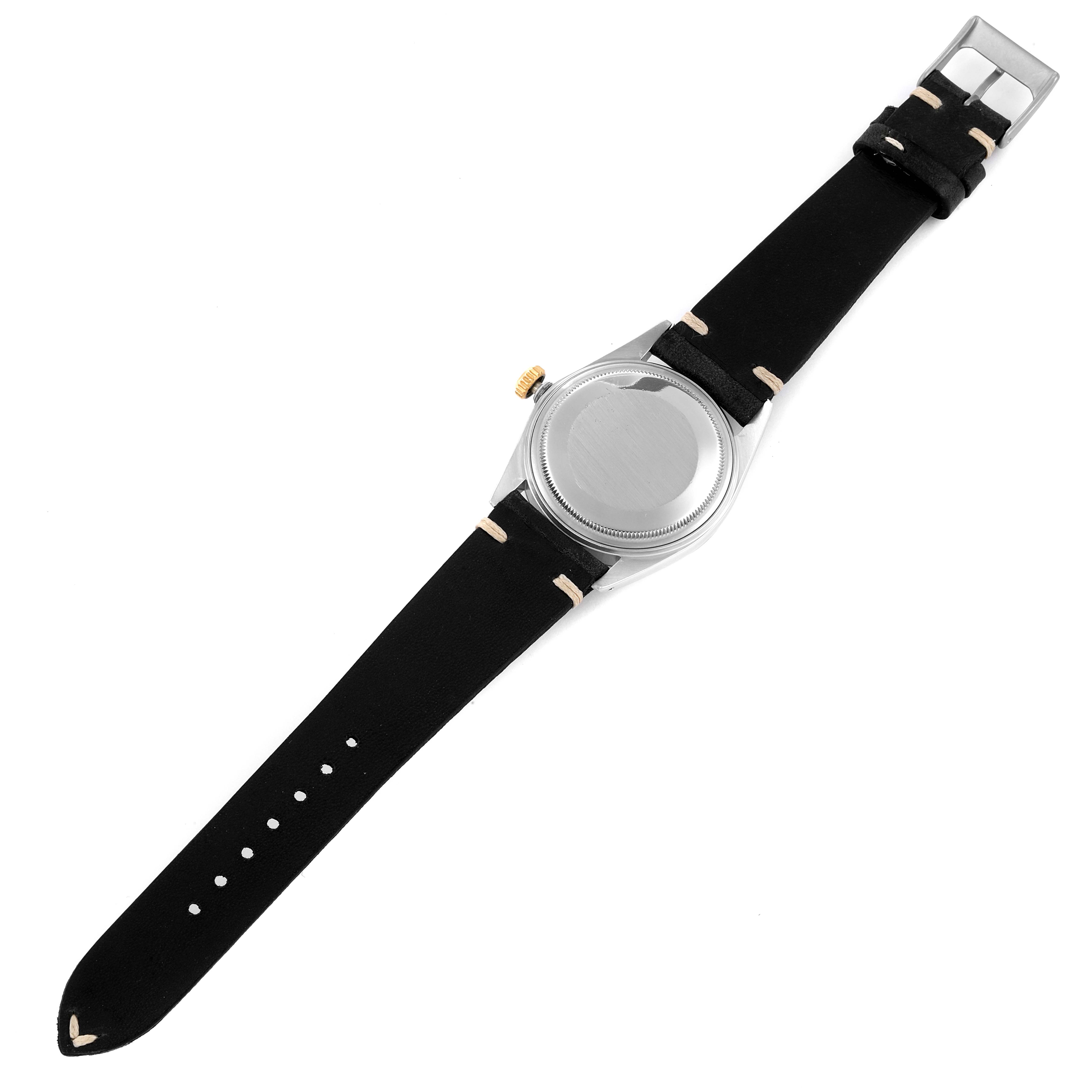 The image shows the back view of a Rolex Vintage Collection 16013 Men's Steel and Gold (two tone) Champagne Dial 16013 Men's Steel and Gold (two tone) Champagne Dial watch with a black strap.