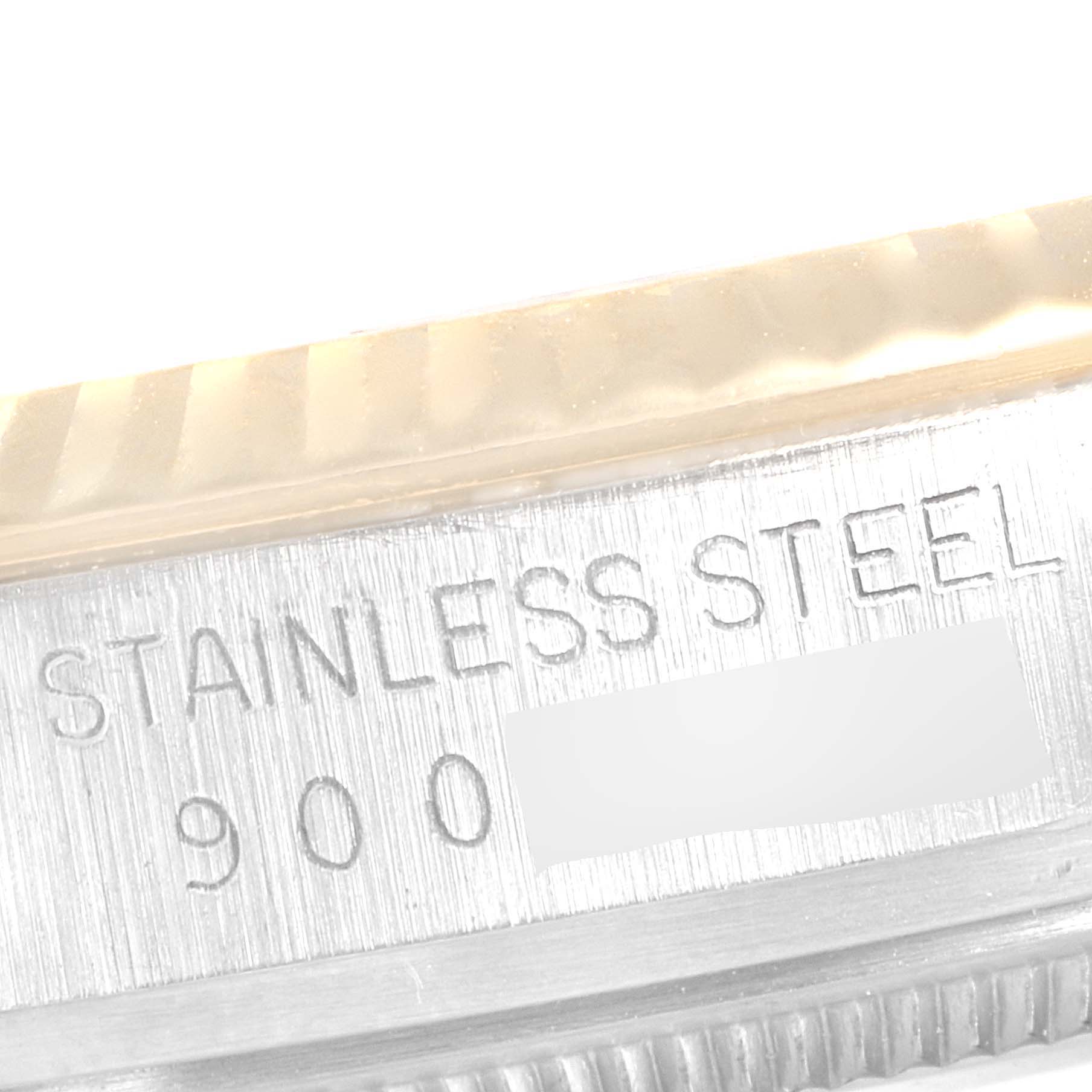 This close-up image shows the inscription "STAINLESS STEEL" on the outer rim of the Rolex Vintage Collection 16013 Men's Steel and Gold (two tone) Champagne Dial 16013 Men's Steel and Gold (two tone) Champagne Dial watch model.