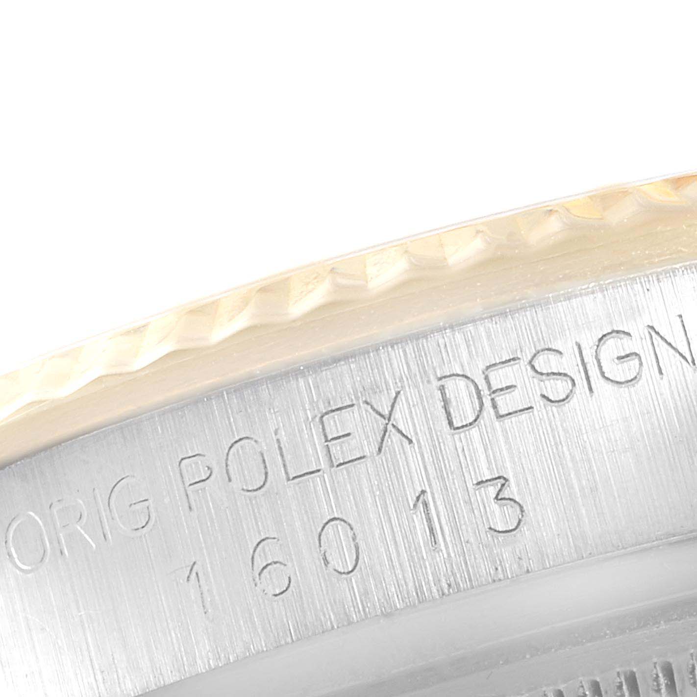 A close-up of the Rolex Vintage Collection 16013 Men's Steel and Gold (two tone) Champagne Dial 16013 Men's Steel and Gold (two tone) Champagne Dial watch's bezel and serial number engraved on the case side.