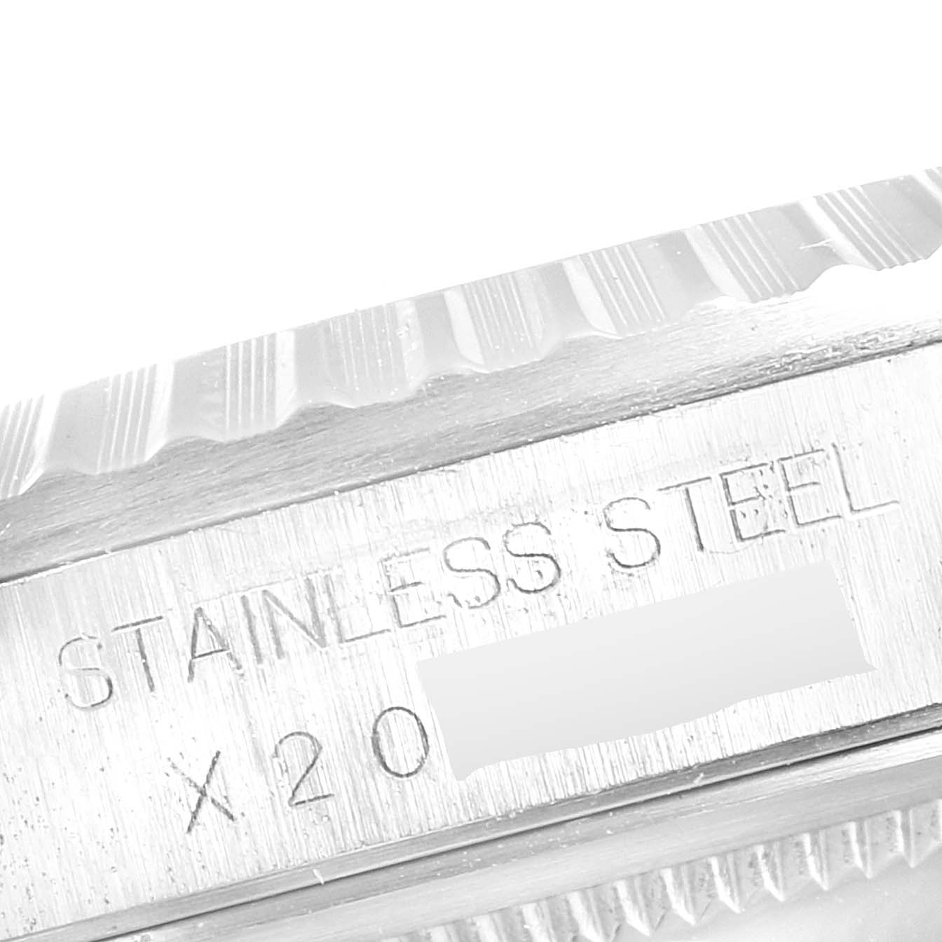 This image shows a close-up of the side of a Rolex Datejust 16220 Men
s Stainless Steel Black Dial 16220 Men
s Stainless Steel Black Dial watch, highlighting "STAINLESS STEEL" engraving.