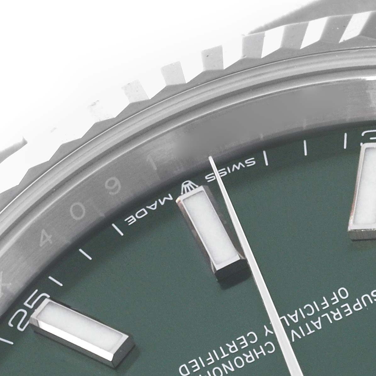 This close-up image of the Rolex Datejust 41 126334 Men
s Stainless Steel Green Dial 126334 Men
s Stainless Steel Green Dial shows the dial, hour markers, and part of the fluted bezel.