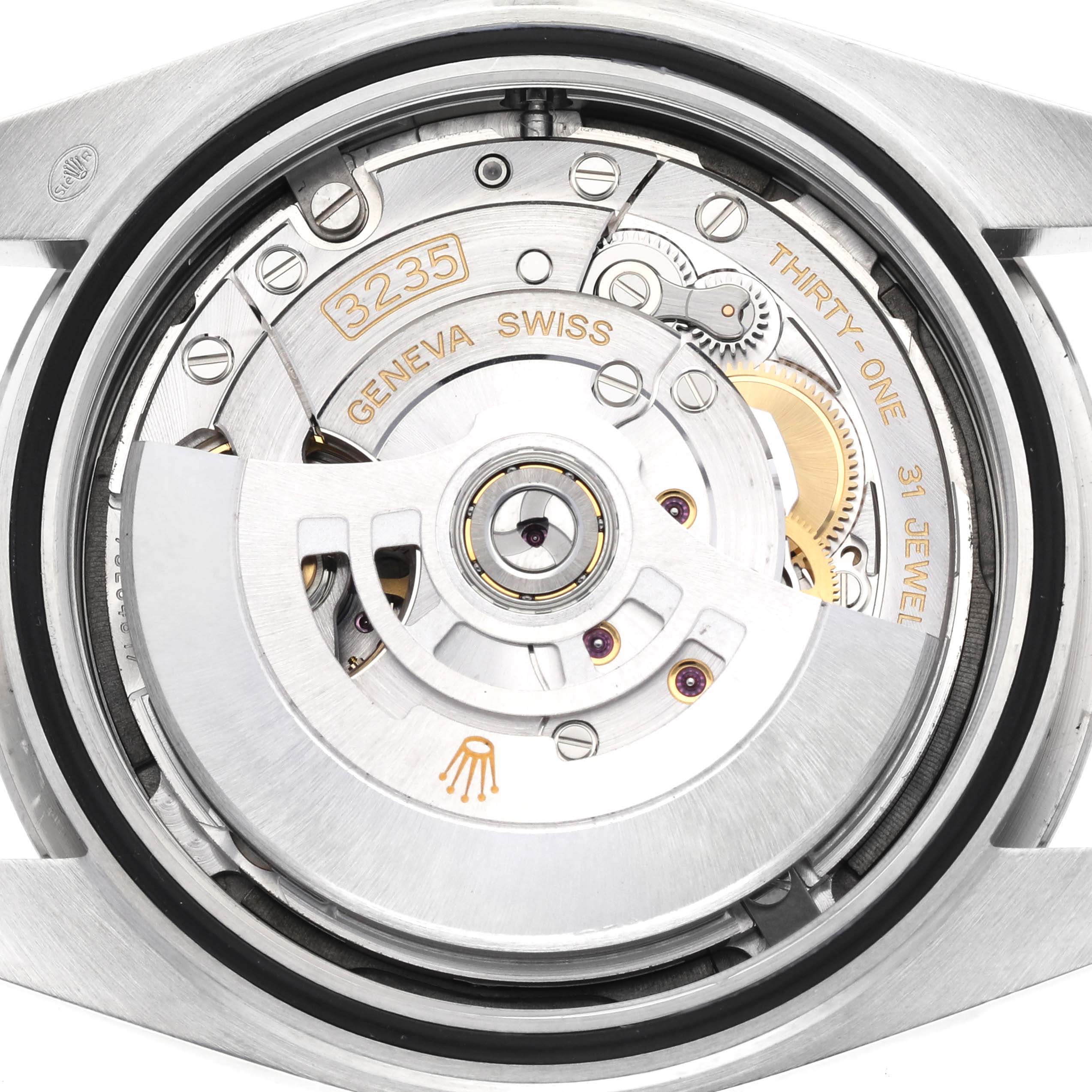 The image shows the inner mechanism of a Rolex Datejust 41 126334 Men
s Stainless Steel Green Dial 126334 Men
s Stainless Steel Green Dial watch, focusing on the movement with the rotor and gears visible.