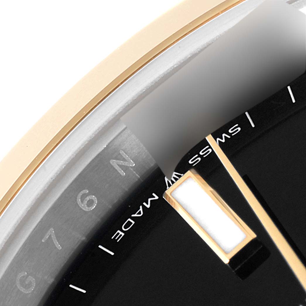 This close-up shows a portion of the dial and the minute hand of the Rolex Datejust 41 126303 Men's Steel and Gold (two tone) Black Dial 126303 Men's Steel and Gold (two tone) Black Dial, highlighting the "SWISS MADE" label.