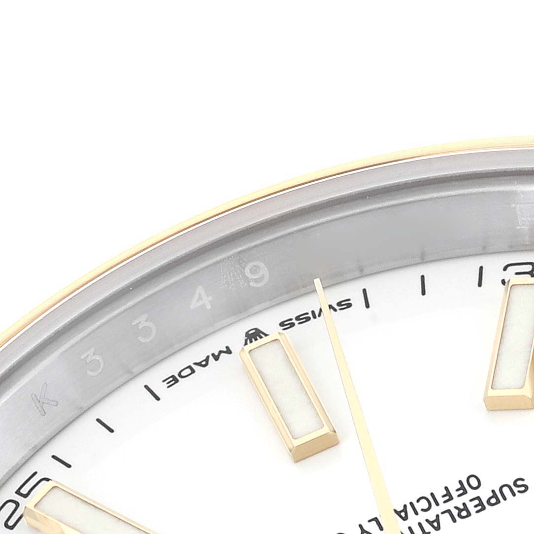 This image shows a partial close-up view of the dial and bezel of a Rolex Datejust 41 126303 Men's Steel and Gold (two tone) White Dial 126303 Men's Steel and Gold (two tone) White Dial watch.