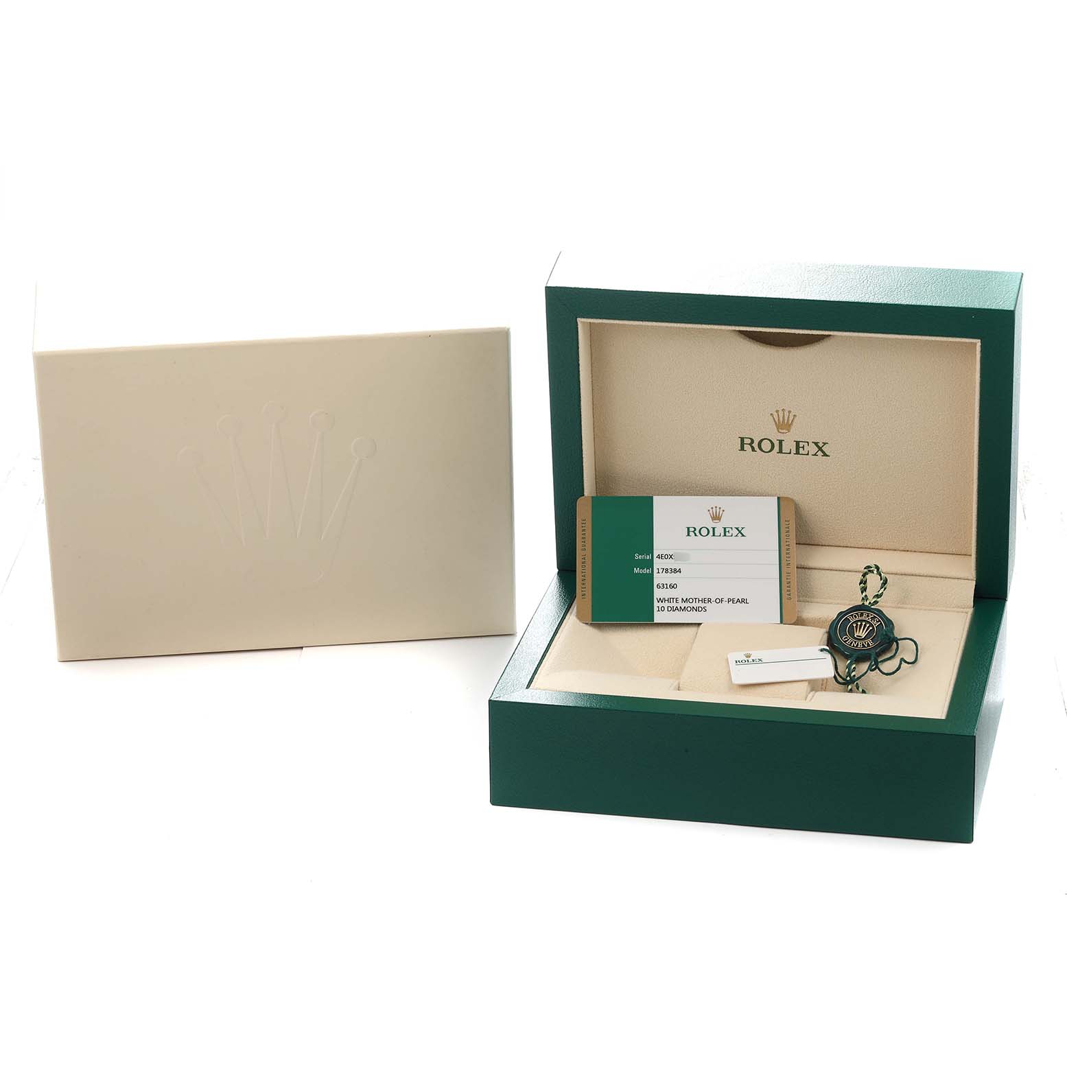 The image shows a Rolex Mid-Size 178384 Women
s Stainless Steel Mother of Pearl Dial model watch box open, revealing a warranty card and a tag positioned inside.