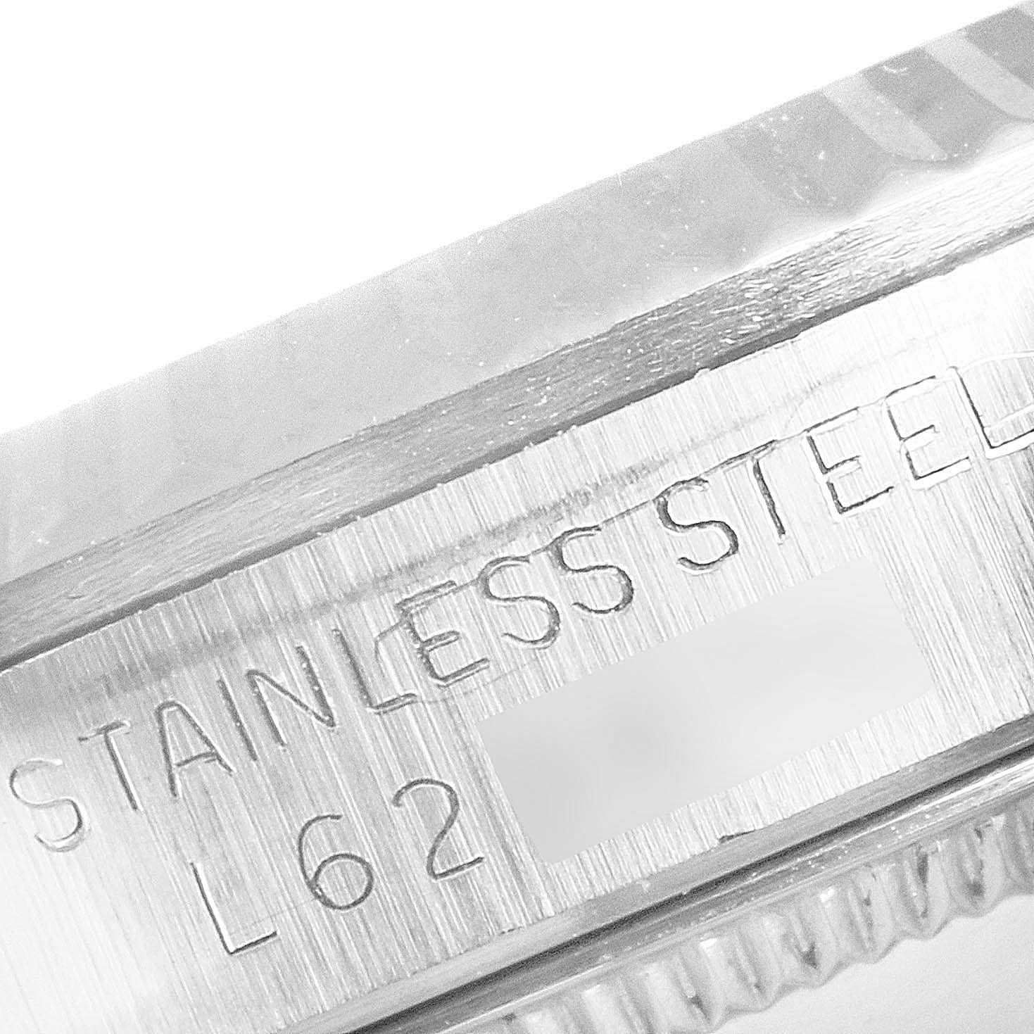 Close-up of the side of the case on a mid-size Rolex watch, showing "STAINLESS STEEL" engraving.