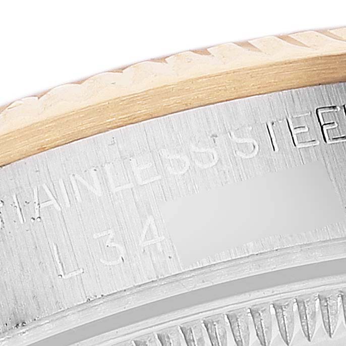 Close-up of the stainless steel case and bezel edge of a Rolex Datejust 68273 Women's Steel and Gold (two tone) Champagne Dial 68273 Women's Steel and Gold (two tone) Champagne Dial, showing engraved text.