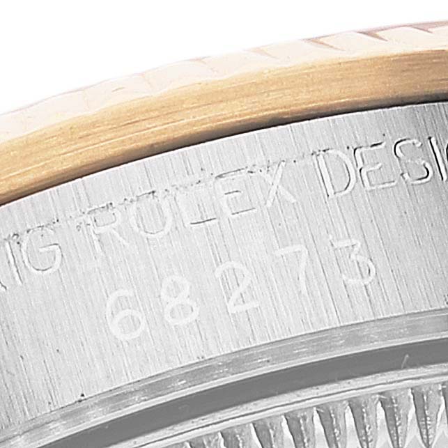 The image shows a close-up of the side of a Rolex Datejust 68273 Women's Steel and Gold (two tone) Champagne Dial 68273 Women's Steel and Gold (two tone) Champagne Dial, featuring the case with its engraved design and model number.