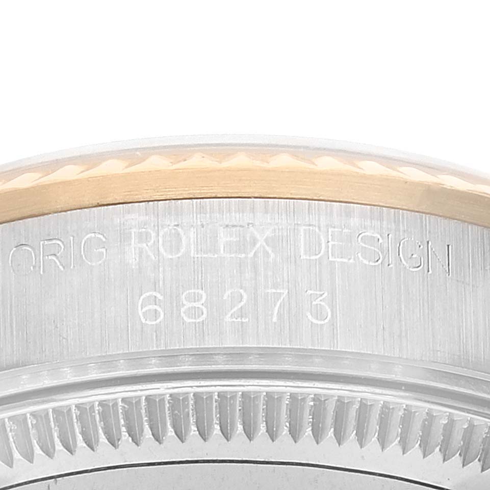 This image shows a close-up of the case side of a Rolex Mid-Size 68273 Women
s Steel and Gold (two tone) Champagne Dial 68273 Women
s Steel and Gold (two tone) Champagne Dial model, emphasizing the engraved serial numbers and design details.