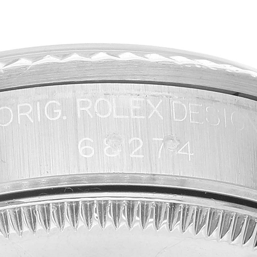 This image shows a close-up, detailed view of the casing and serial number area of a mid-size Rolex watch.