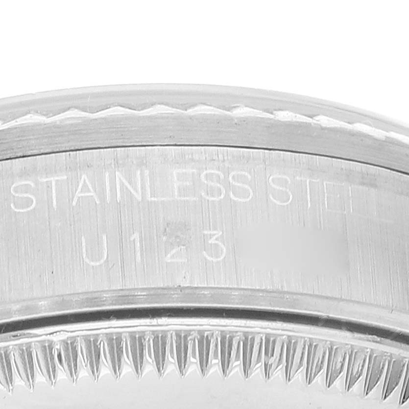 This image shows a close-up of the stainless steel rim and serial number of a Rolex Mid-Size 68274 Women
s Stainless Steel Black Dial 68274 Women
s Stainless Steel Black Dial model watch.