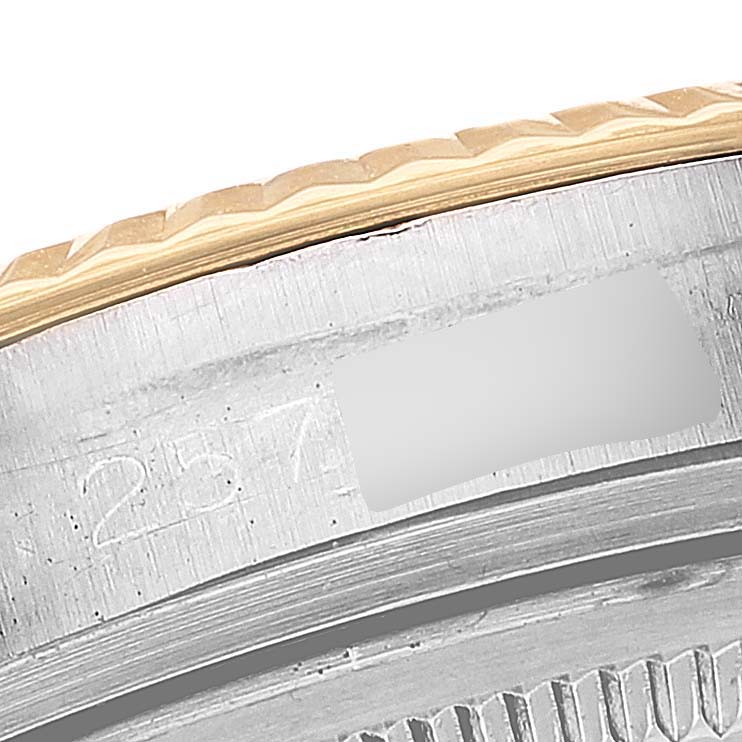 This image shows a close-up of the case edge and bezel of the Rolex Vintage Collection 1601 Men
s Steel and Gold (two tone) Silver Dial 1601 Men
s Steel and Gold (two tone) Silver Dial model with visible serial engraving.