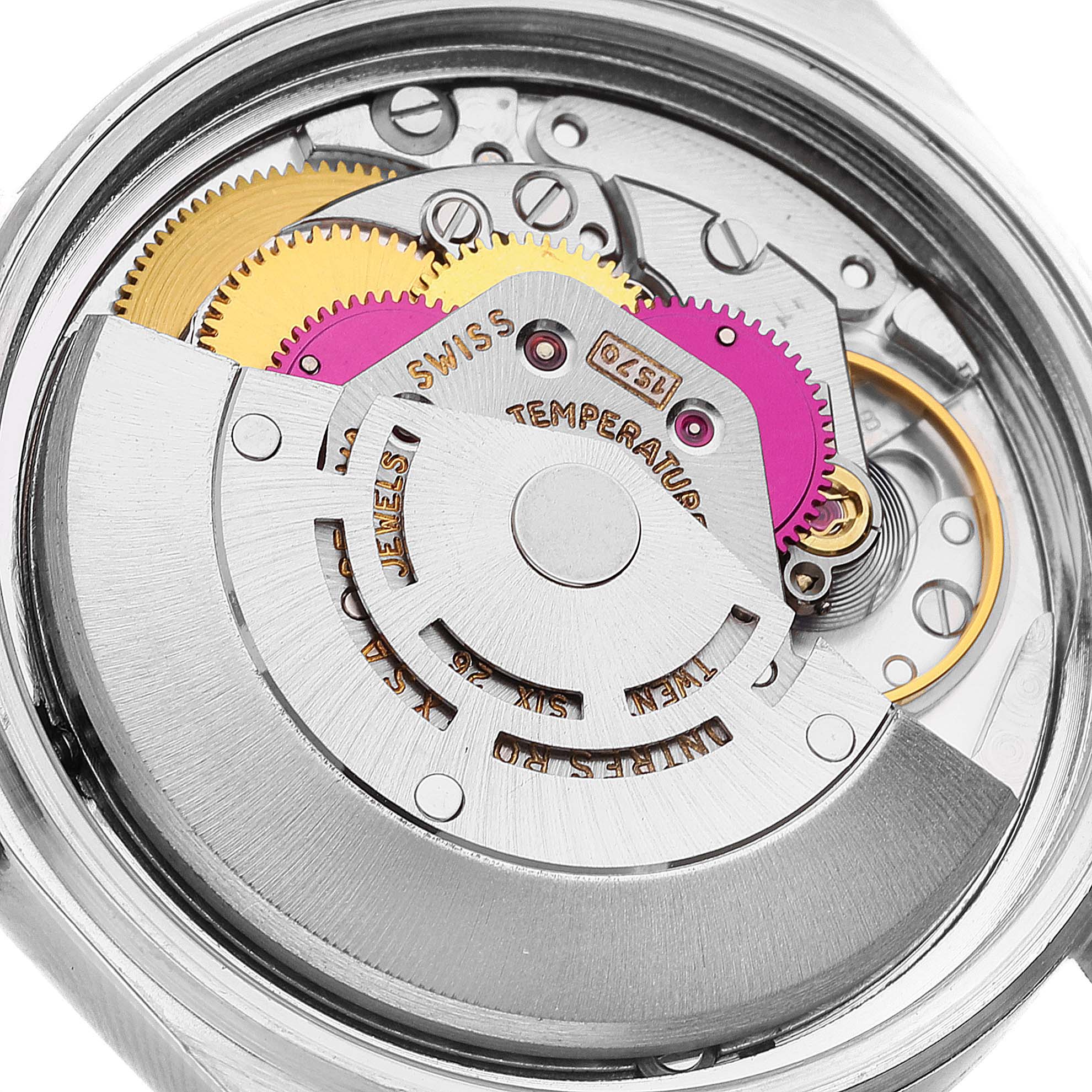 The image shows the internal mechanism of a Rolex Vintage Collection 1601 Men
s Steel and Gold (two tone) Silver Dial 1601 Men
s Steel and Gold (two tone) Silver Dial model, including gears and the movement assembly.