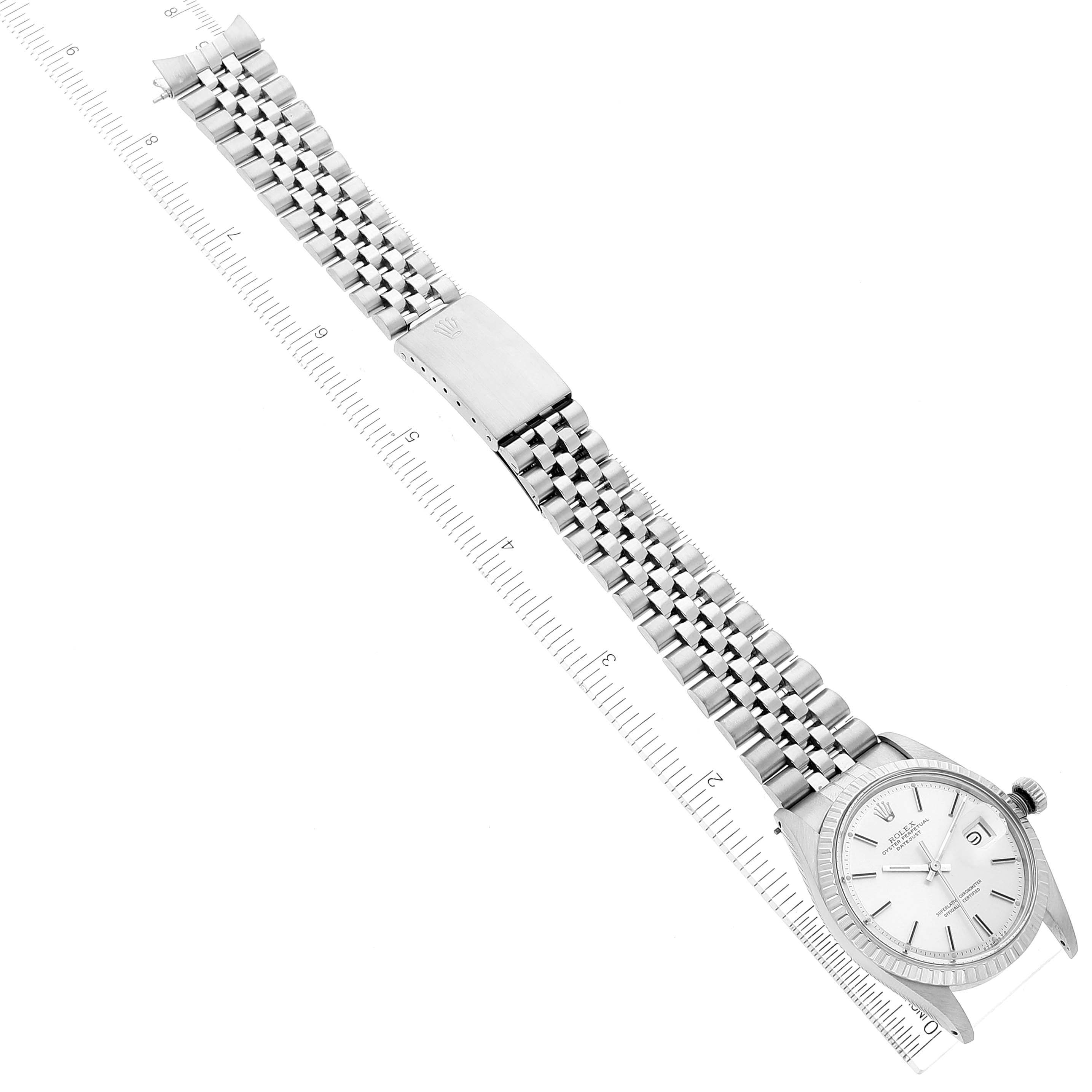 The image shows a Rolex Datejust 1603 Men
s Stainless Steel Silver Dial 1603 Men
s Stainless Steel Silver Dial watch lying flat with its face, bracelet, and clasp fully visible against a measurement ruler.