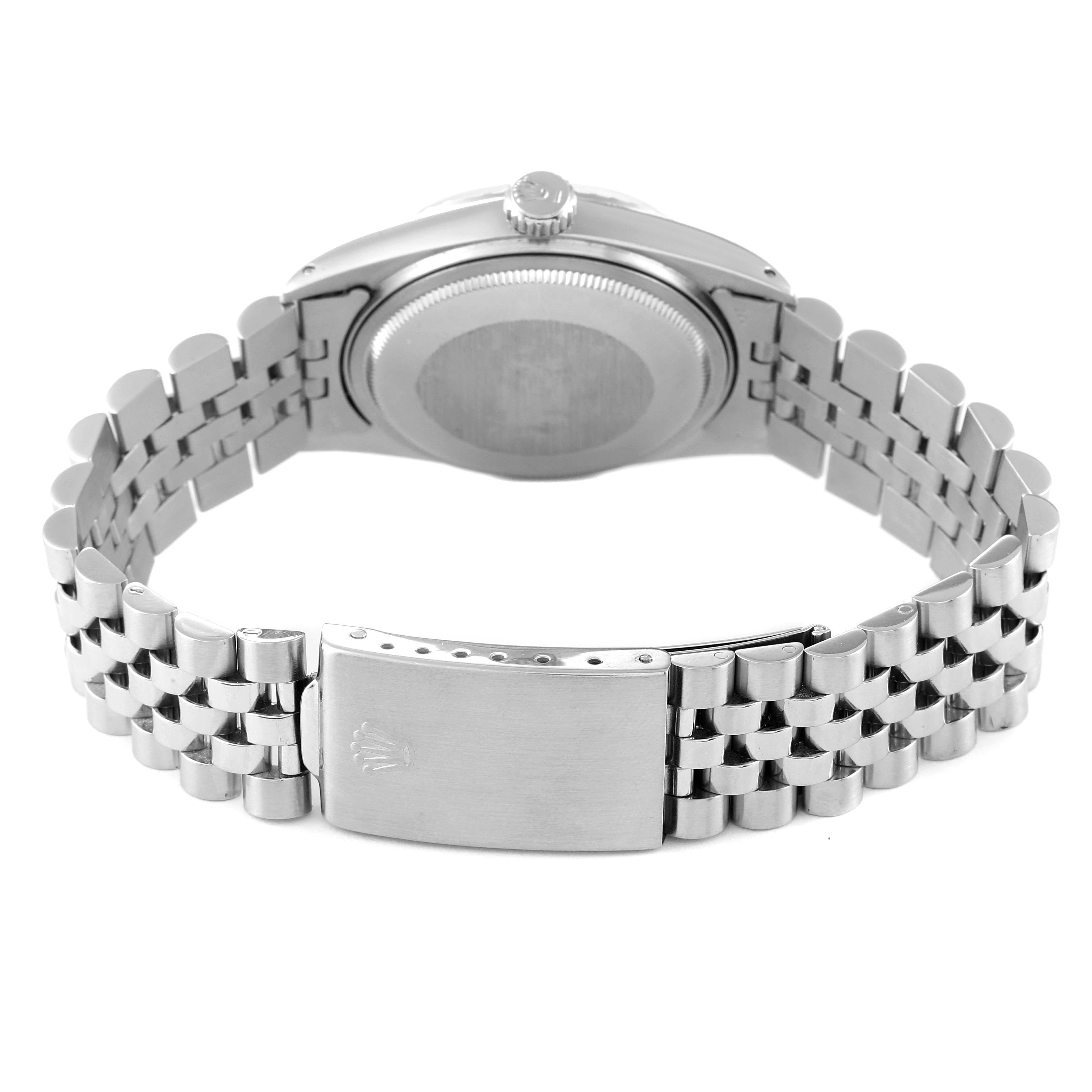 The image shows the backside and clasp of a Rolex Datejust 1603 Men
s Stainless Steel Silver Dial 1603 Men
s Stainless Steel Silver Dial watch, highlighting its metal bracelet and caseback.