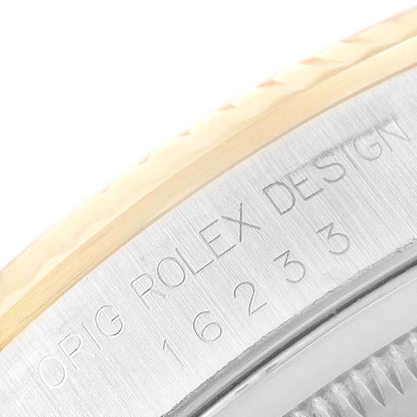 The image shows a close-up angle of the Rolex Datejust 16233 Men
s Steel and Gold (two tone) Champagne Dial 16233 Men
s Steel and Gold (two tone) Champagne Dial
s case side, featuring engraved text and part of the bezel.