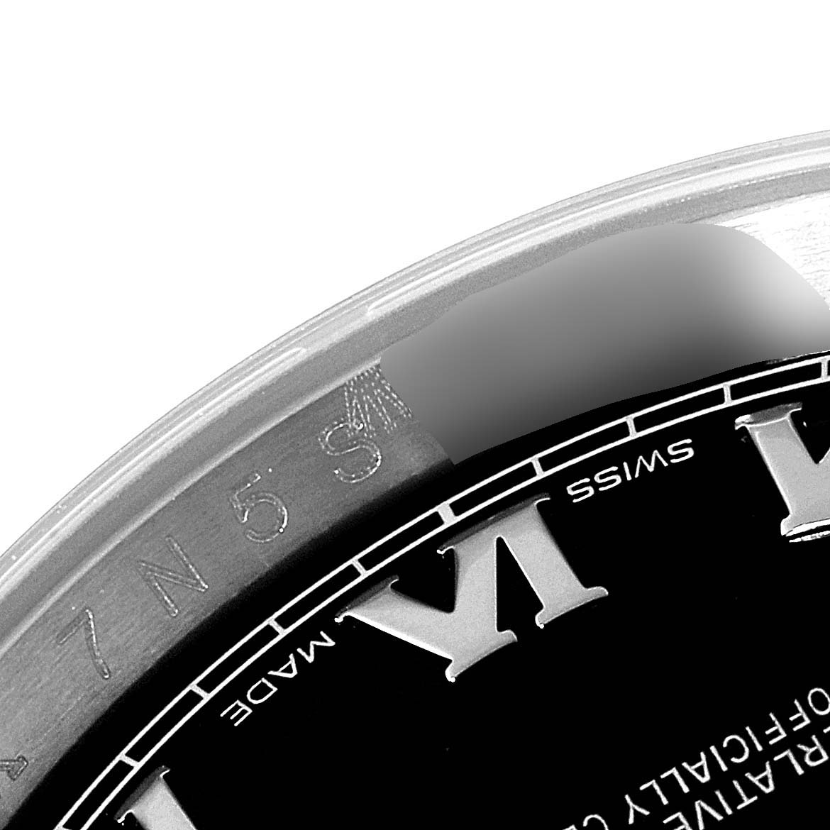 The image shows a close-up of the dial and bezel of a Rolex Datejust 116234 Men's Stainless Steel Black Dial 116234 Men's Stainless Steel Black Dial watch, focusing on the Roman numeral VI (6) and a portion of the serial number.