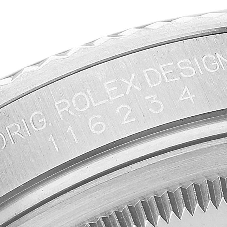 Close-up of the bezel and part of the case of a Rolex Datejust 116234 Men's Stainless Steel Black Dial 116234 Men's Stainless Steel Black Dial, showing the engraved design and model number.
