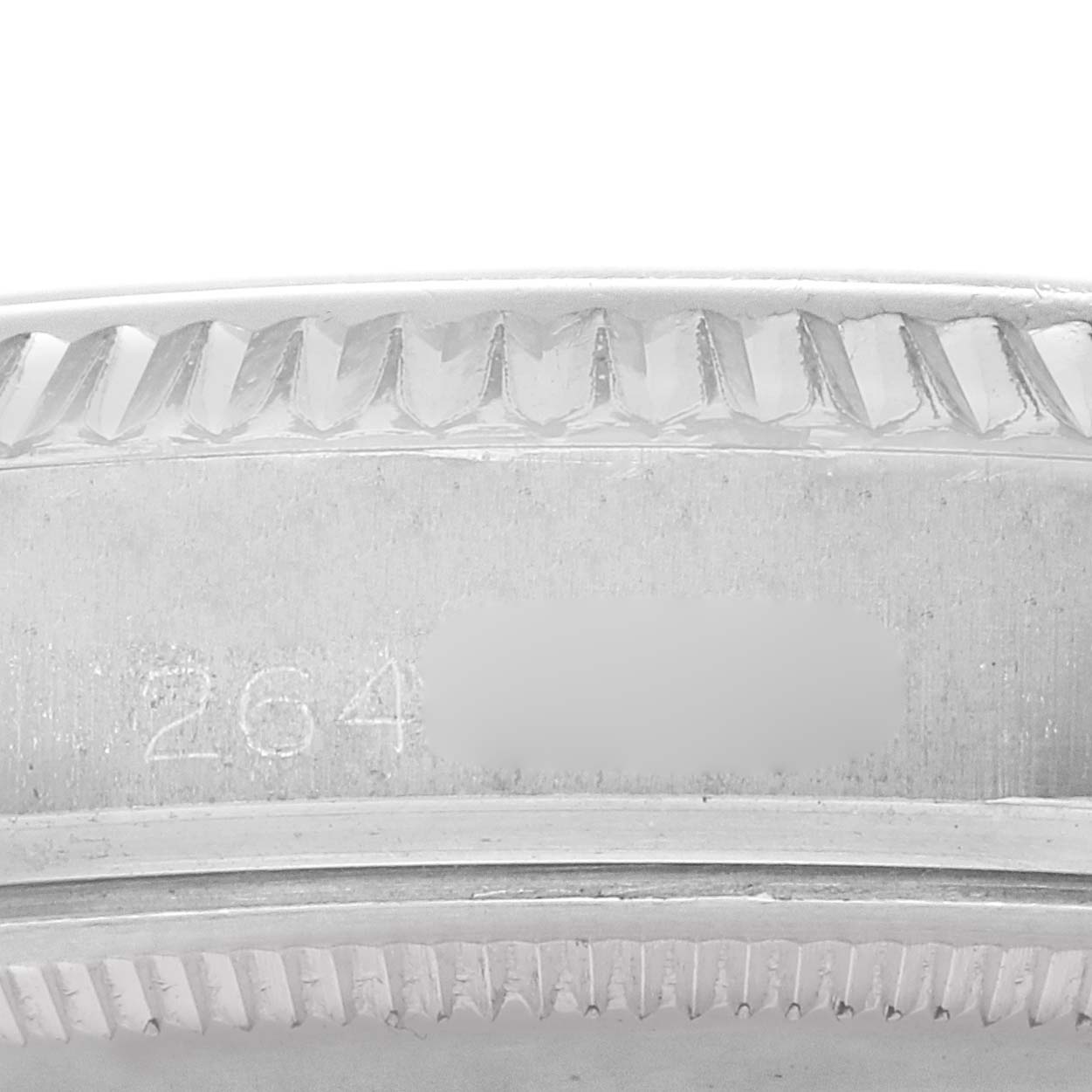 The image shows the edge and engraving of a Rolex Datejust 1601 Men
s Stainless Steel Grey Dial bezel, highlighting the fluted design.