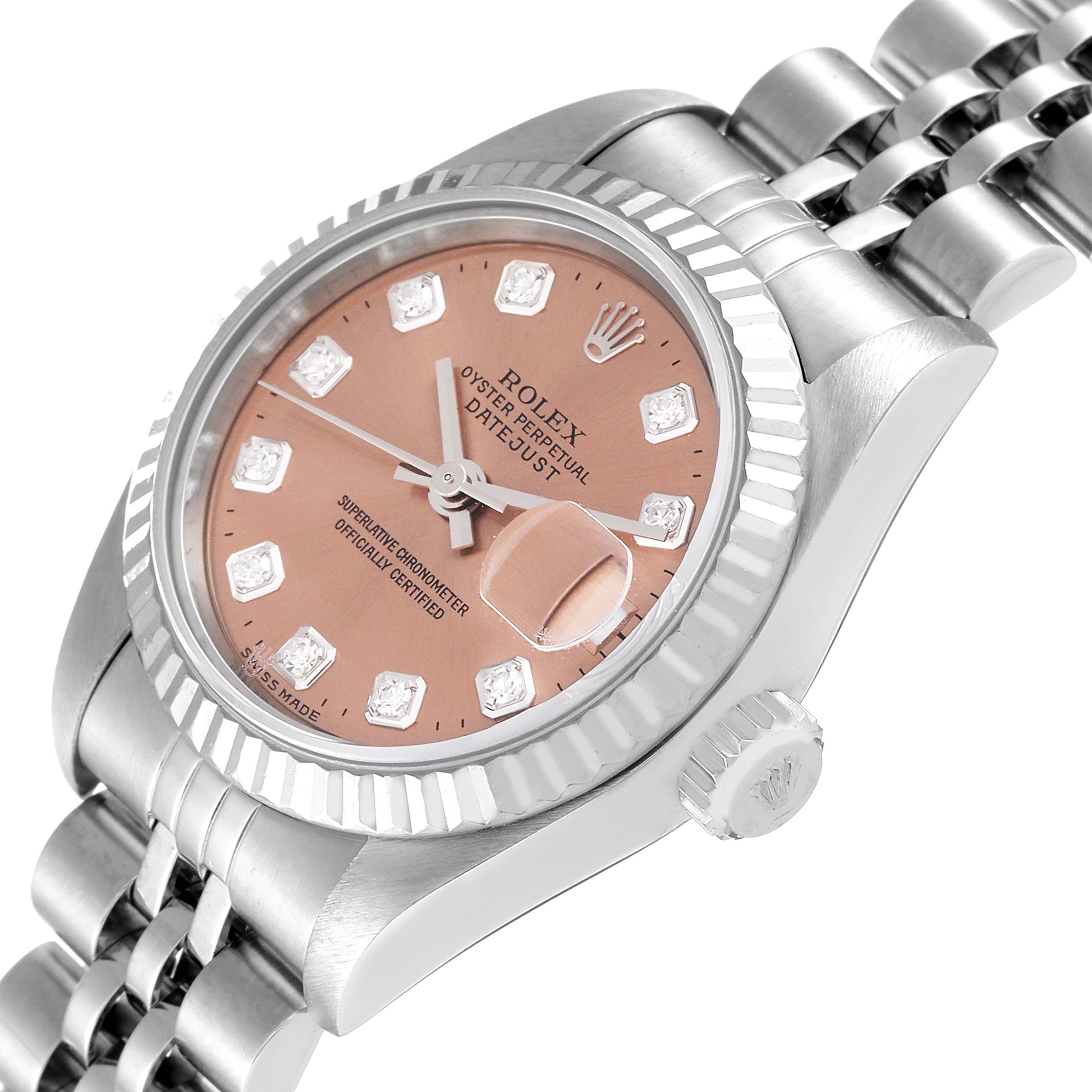 This image shows a close-up of the Rolex Datejust 79174 Women
s Stainless Steel Pink Dial 79174 Women
s Stainless Steel Pink Dial watch at an angle displaying the face, bezel, crown, and part of the bracelet.