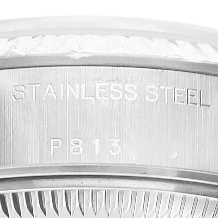 The image shows the side view of the Rolex Datejust 79174 Women
s Stainless Steel Pink Dial 79174 Women
s Stainless Steel Pink Dial watch’s case with "STAINLESS STEEL" and serial number engraved.