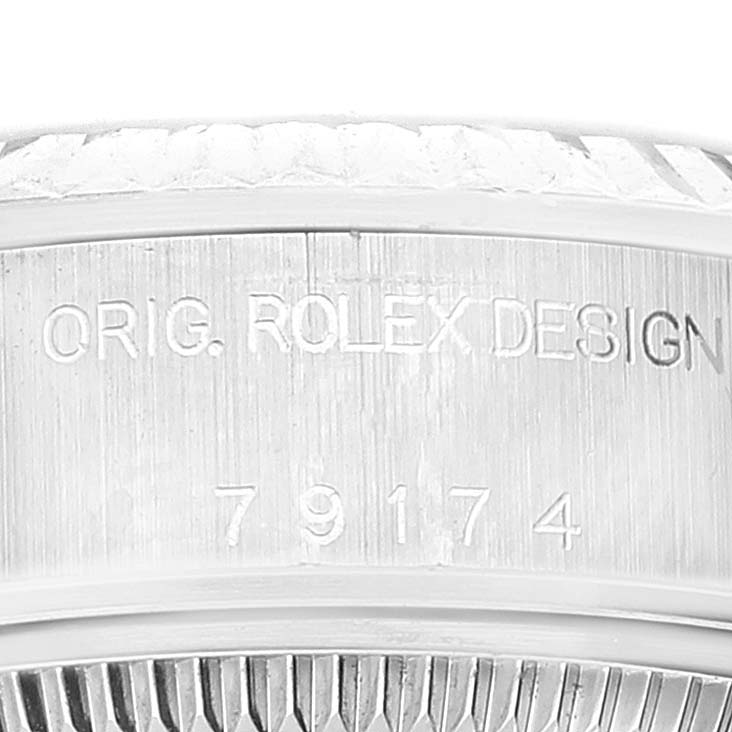 This image shows a close-up of the side of the Rolex Datejust 79174 Women
s Stainless Steel Pink Dial 79174 Women
s Stainless Steel Pink Dial watch case with the engraving "ORIG. ROLEX DESIGN" and model number.