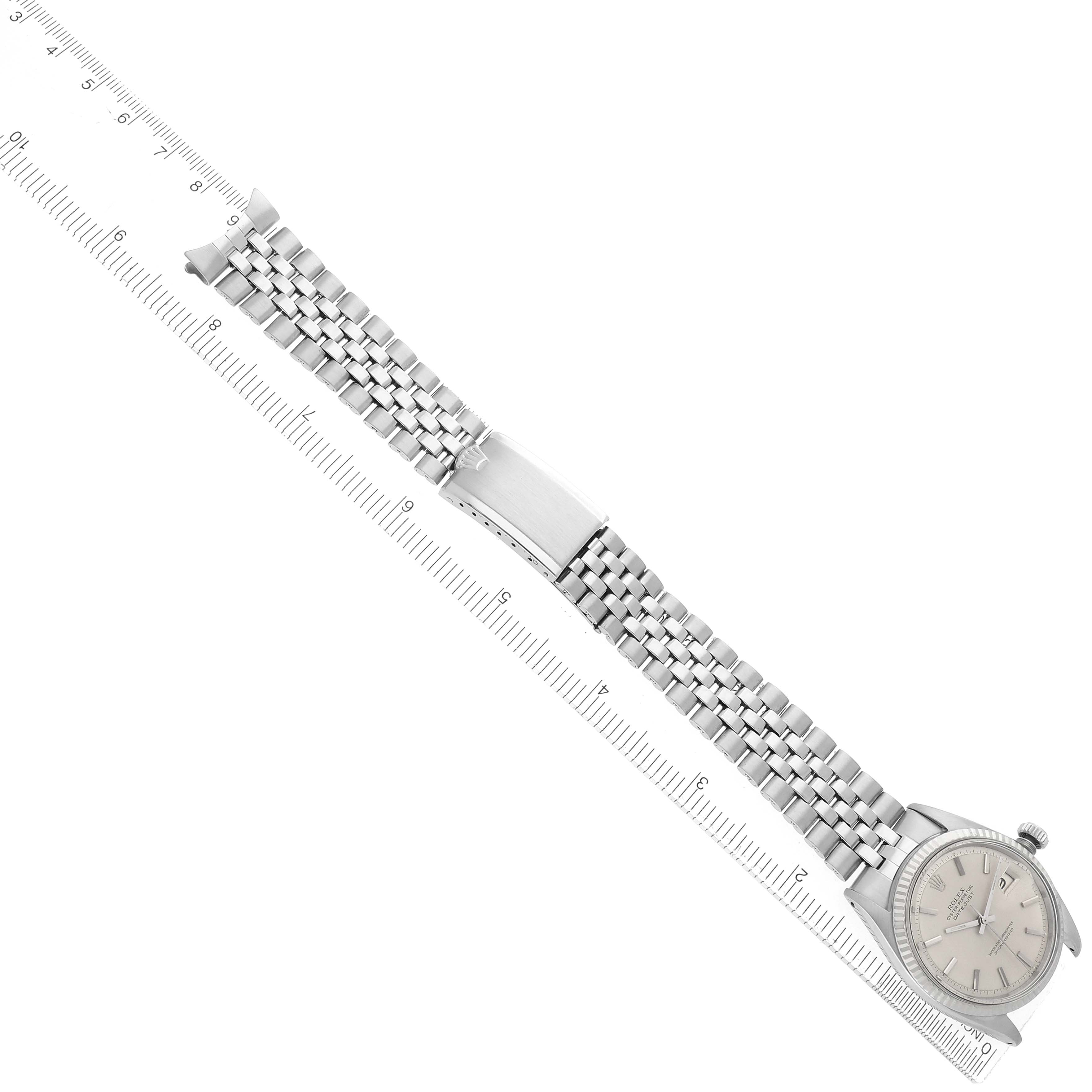 The Rolex Vintage Collection 1601 Men
s Stainless Steel Silver Dial watch is shown from a top view, displaying the full watch, dial, and bracelet alongside a ruler.