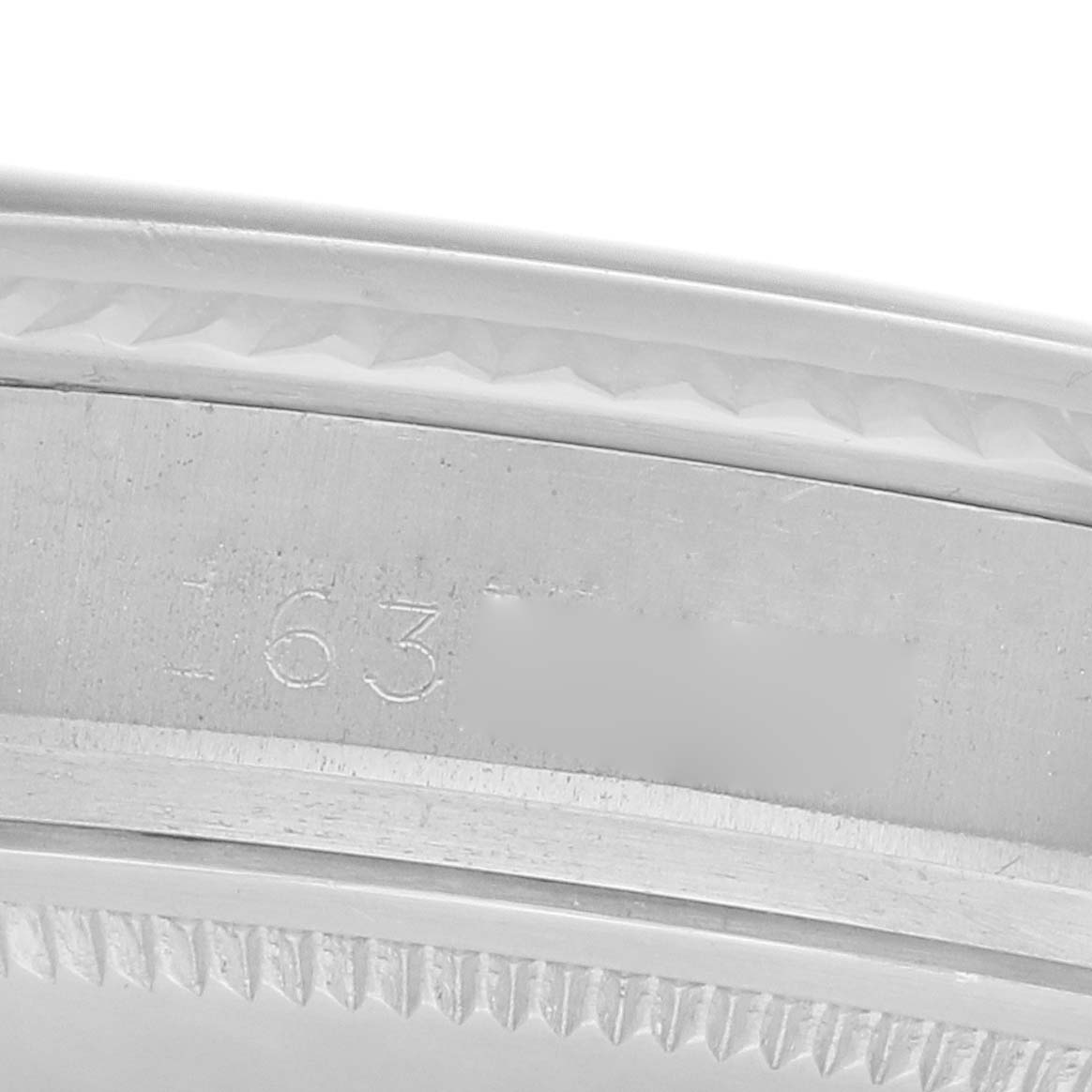 The image shows a close-up of the Rolex Vintage Collection 1601 Men
s Stainless Steel Silver Dial model
s engraved case edge and bezel.