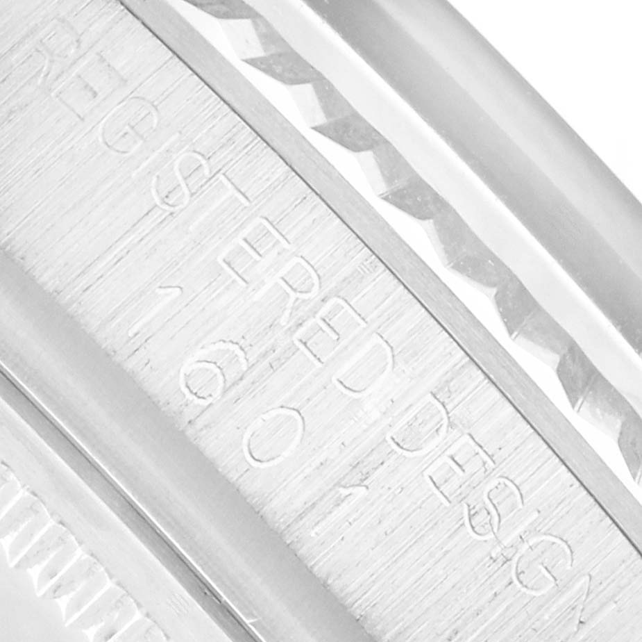 The image shows a close-up of the engraved inner bezel (rehaut) of a Rolex Datejust 1601 Men
s Stainless Steel Silver Dial watch.