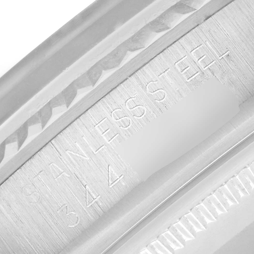 The image shows a close-up of the inner bezel of a Rolex Datejust 1601 Men
s Stainless Steel Silver Dial, highlighting the "STAINLESS STEEL" engraving.