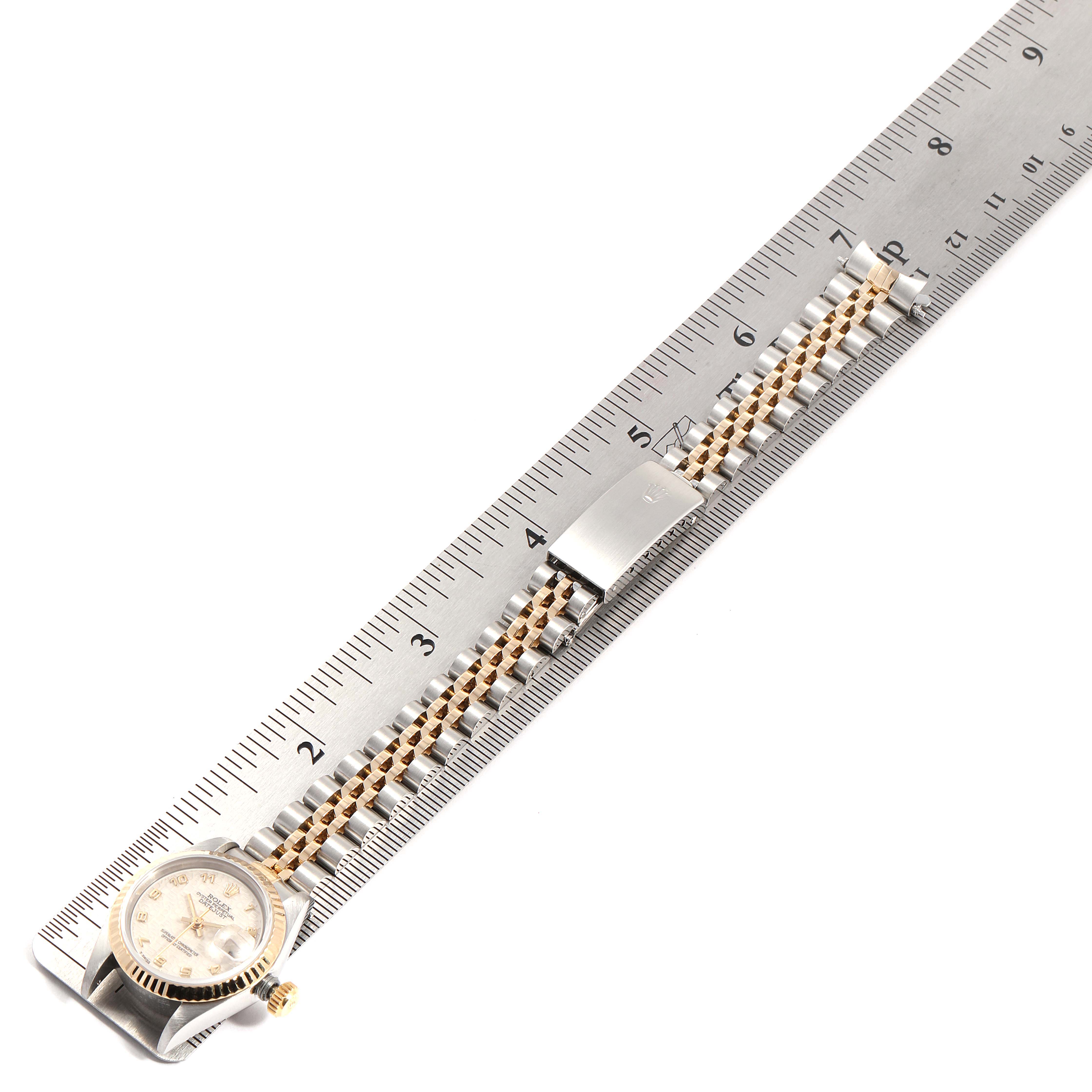 This image shows a Rolex Datejust 69173 Women's Steel and Gold (two tone) Beige Dial 69173 Women's Steel and Gold (two tone) Beige Dial watch, laid flat alongside a ruler, displaying the face and bracelet.